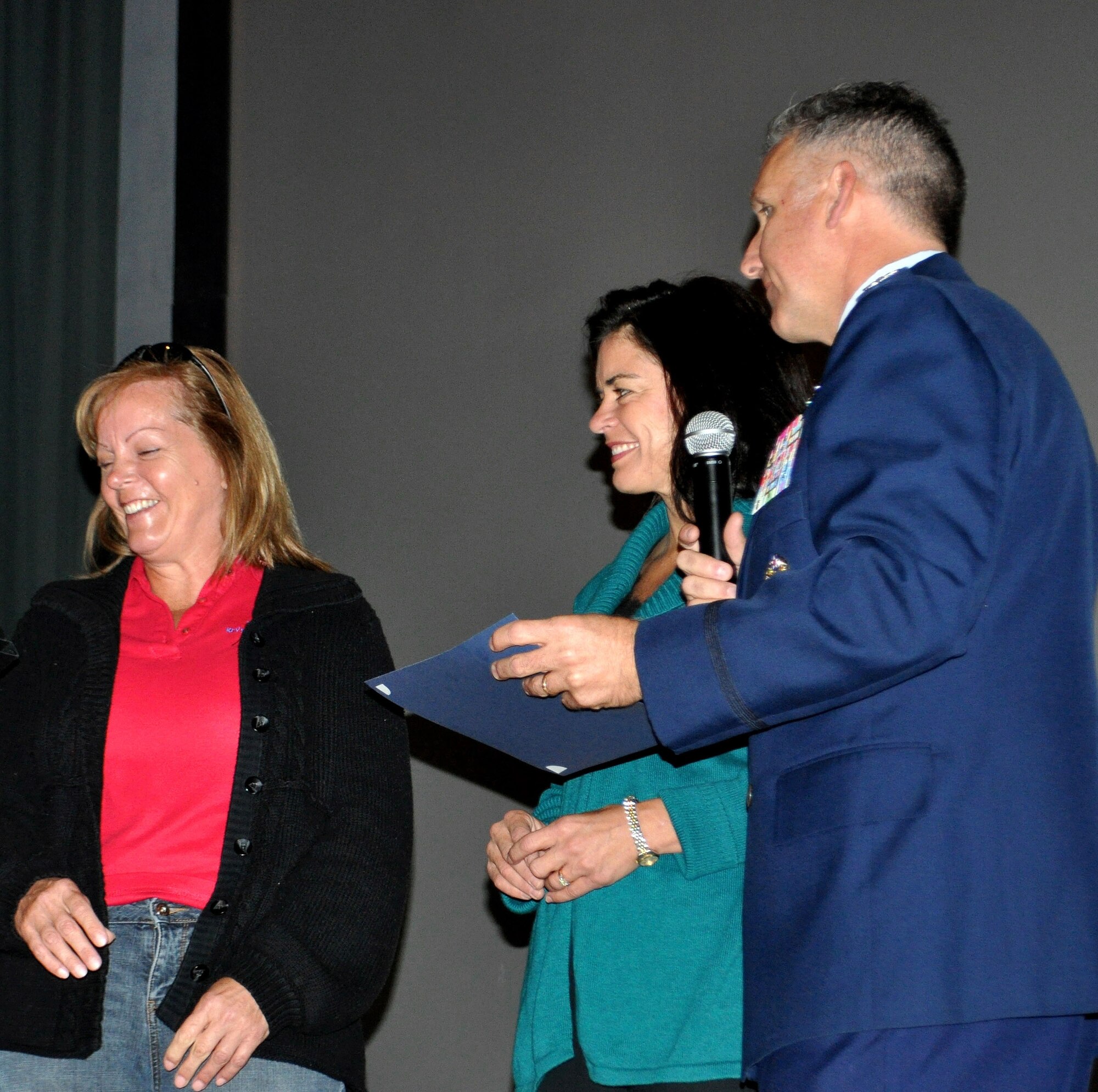 TRAVIS AIR FORCE BASE, Calif. -- 349th AMW Commander, Col. Jay Flournoy, and his wife, Anne, present Mrs. Catherine Thews with a gift and certificate of recognition. Mrs. Thews, mentored by Mrs. Flournoy, became the Key Spouse for the 945th Aircraft Maintenance Squadron. (U.S. Air Force photo/Staff Sgt. Rachel Martinez).