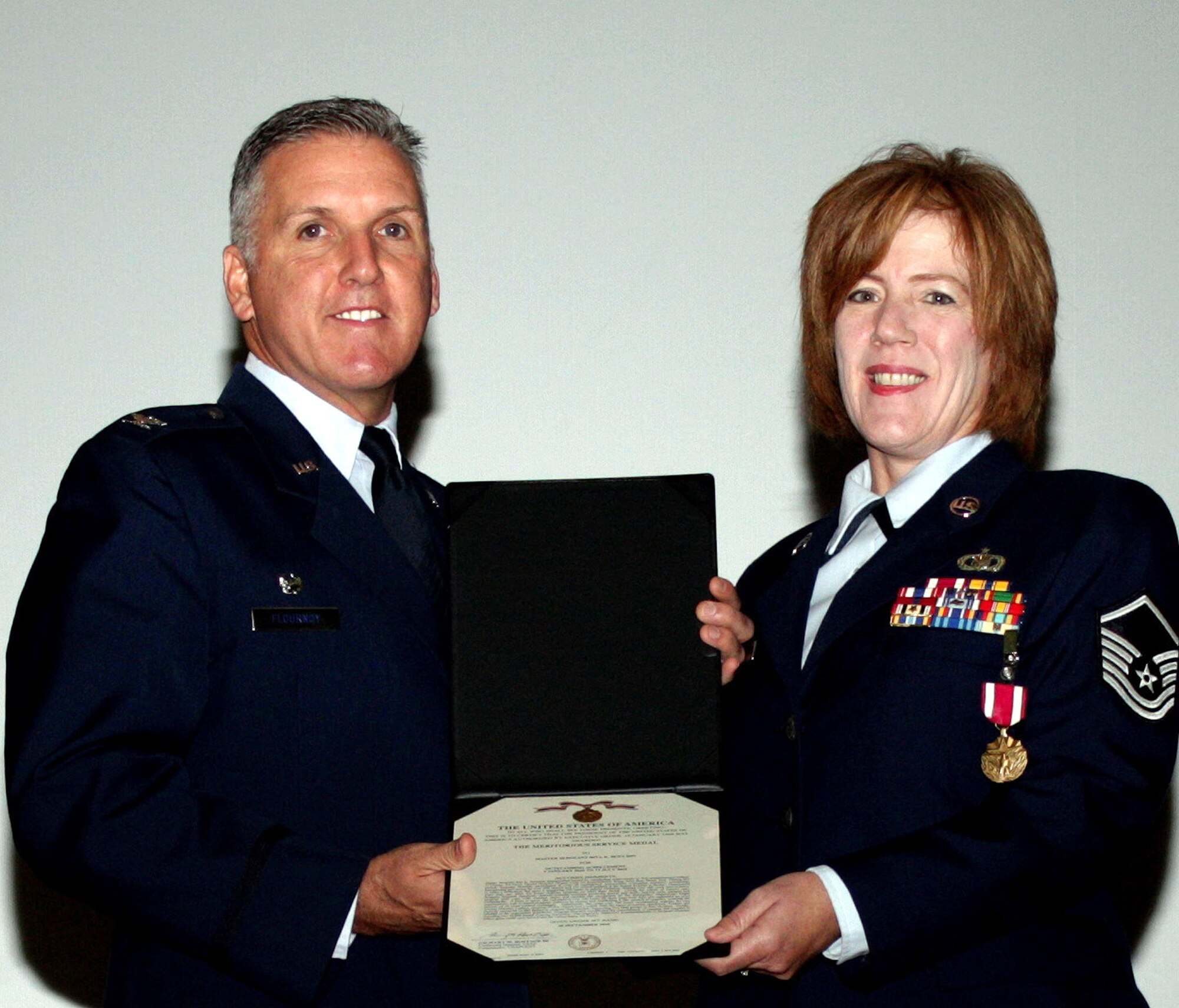 TRAVIS AIR FORCE BASE, Calif. -- Pictured here, Col. Jay Flournoy, wing commander, pinned the Air Force Meritorious Medal on Master Sgt. Rita Houchin, for her performance while deployed to Joint Base Balad. Houchin is a chaplain's assistant with the 349th AMW chaplain office. (U.S. Air Force photo/Senior Amn. Amelia Leonard).