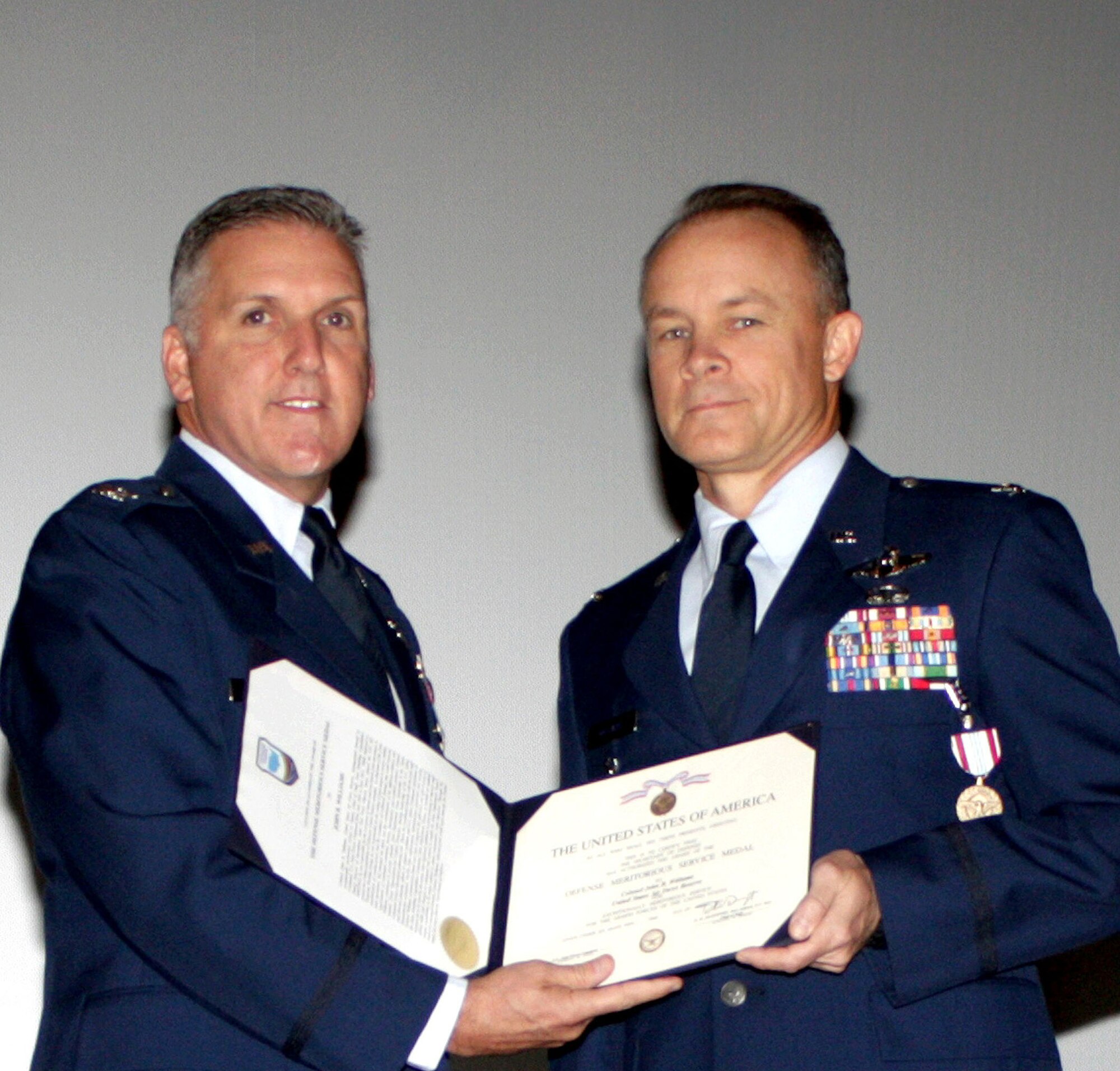 TRAVIS AIR FORCE BASE, Calif. -- At the Nov. 6, 2011 Commander's Call for the 349th Air Mobility Wing, several medals were presented. Col. John Williams, 349th AMW vice commander, on the right, was awarded the Defense Meritorious Service Medal at the Nov. 6 wing commander's call. The medal was presented by Col. Jay Flournoy, wing commander, pictured here. (U.S. Air Force photo/Senior Amn. Amelia Leonard).