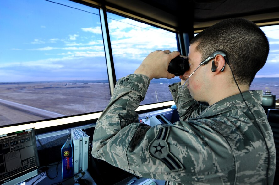Staff Sgt. Tighson Lends His Horse, 28th Operations Support Squadron air traffic controller, communicates with aircraft with an inhanced terminal voice switch at the Air Traffic Control Tower on Ellsworth Air Force Base, S.D., Nov. 15, 2011. Lends His Horse coordinates with pilots to taxi aircraft on and off the runway safely to avoid collisions. (U.S. Air Force photo by Airman 1st Class Zachary Hada/Released) 