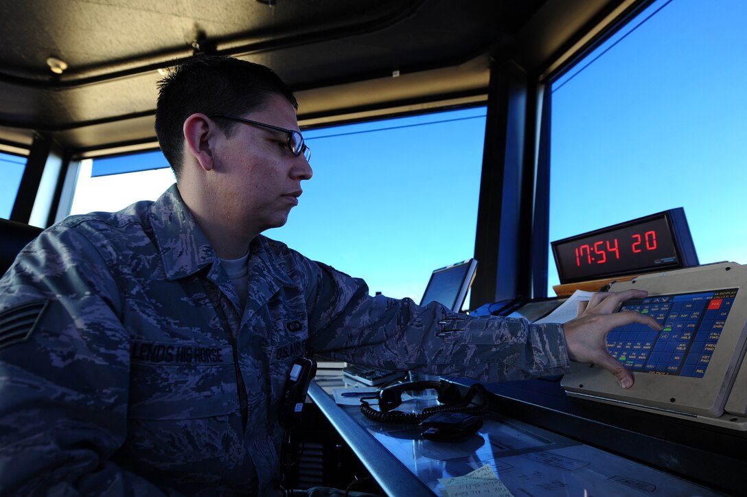 Staff Sgt. Tighson Lends His Horse, 28th Operations Support Squadron air traffic controller, communicates with aircraft with an inhanced terminal voice switch at the Air Traffic Control Tower on Ellsworth Air Force Base, S.D., Nov. 15, 2011. Lends His Horse coordinates with pilots to taxi aircraft on and off the runway safely to avoid collisions. (U.S. Air Force photo by Airman 1st Class Zachary Hada/Released) 