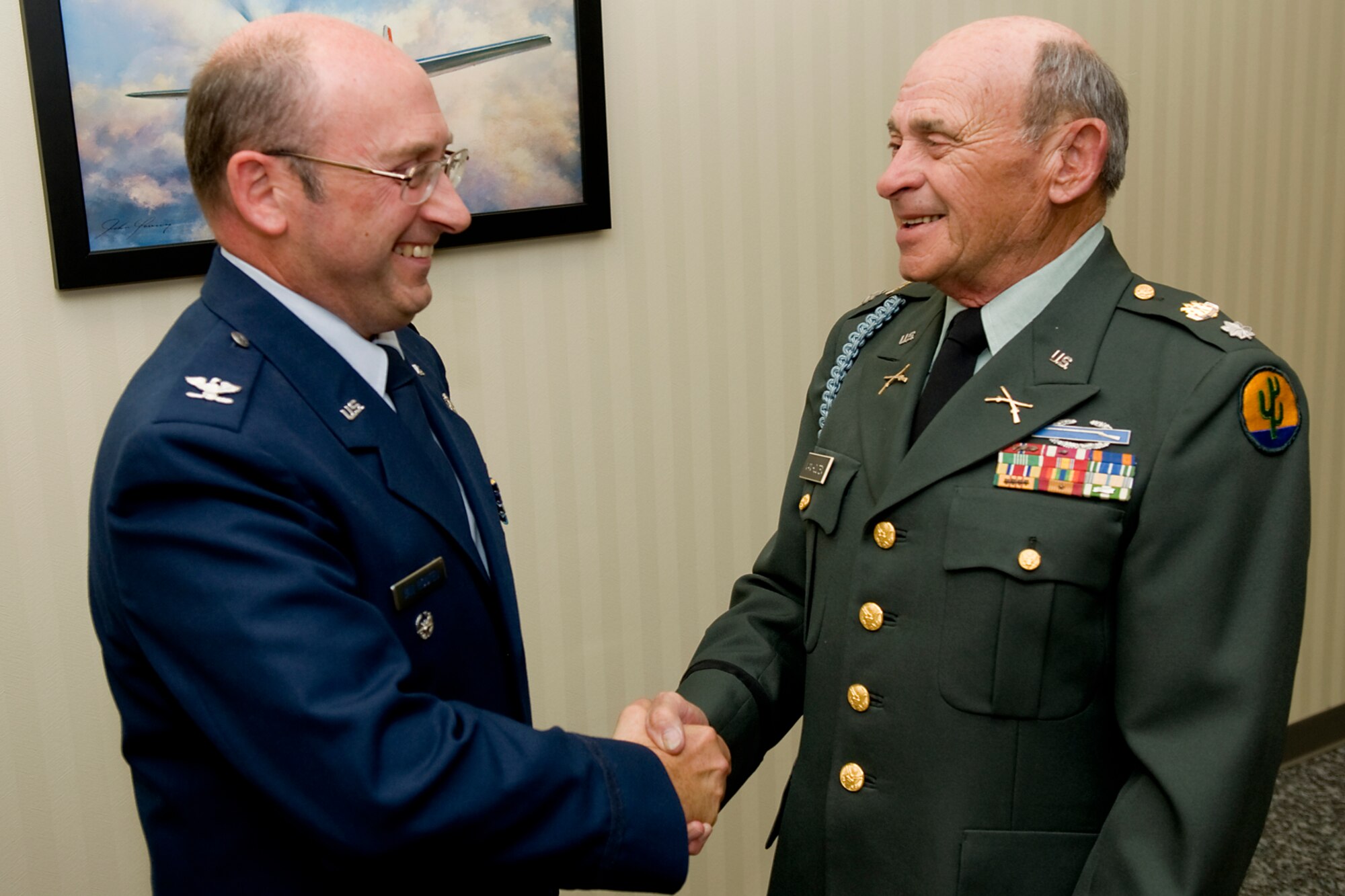 GRISSOM AIR RESERVE BASE, Ind. -- Retired U.S. Army Lt. Col. Arthur L. Van Houten II, right, congratulates his son, Col. Arthur L. Van Houten III, on his recent promotion to full colonel here Oct. 23. The last time the two were in uniform together was the day the father pinned lieutenant bars on his son at his commissioning ceremony. The younger Van Houten served as the 434th Maintenance Group deputy commander until his promotion. He will now serve as the senior individual mobilization augmentee for the 402nd Maintenance Wing commander at Robins Air Force Base, Ga. (U.S. Air Force photo/Tech. Sgt. Mark R. W. Orders-Woempner)
