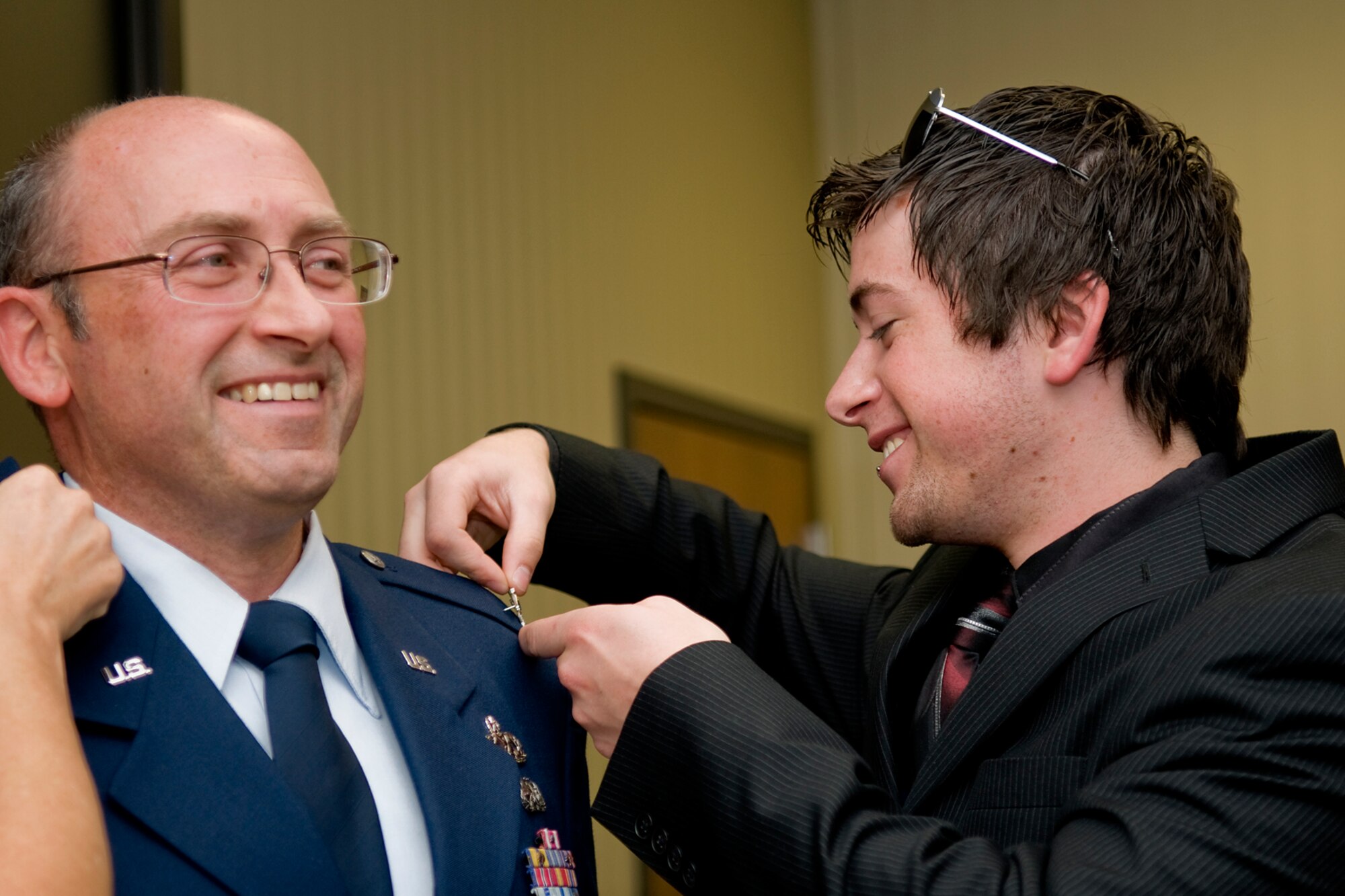 GRISSOM AIR RESERVE BASE, Ind. -- Jared Van Houten pins colonel eagles on his father, Arthur L. Van Houten III, during his promotion ceremony Oct. 23. Colonel Van Houten served as the 434th Maintenance Group deputy commander until his promotion. He will now serve as the senior individual mobilization augmentee for the 402nd Maintenance Wing commander at Robins Air Force Base, Ga. The 402nd MXW provides depot maintenance, engineering support and software development to major weapon systems including F-15s, C-5s, C-130s, C-17s and special operations aircraft. (U.S. Air Force photo/Tech. Sgt. Mark R. W. Orders-Woempner)
