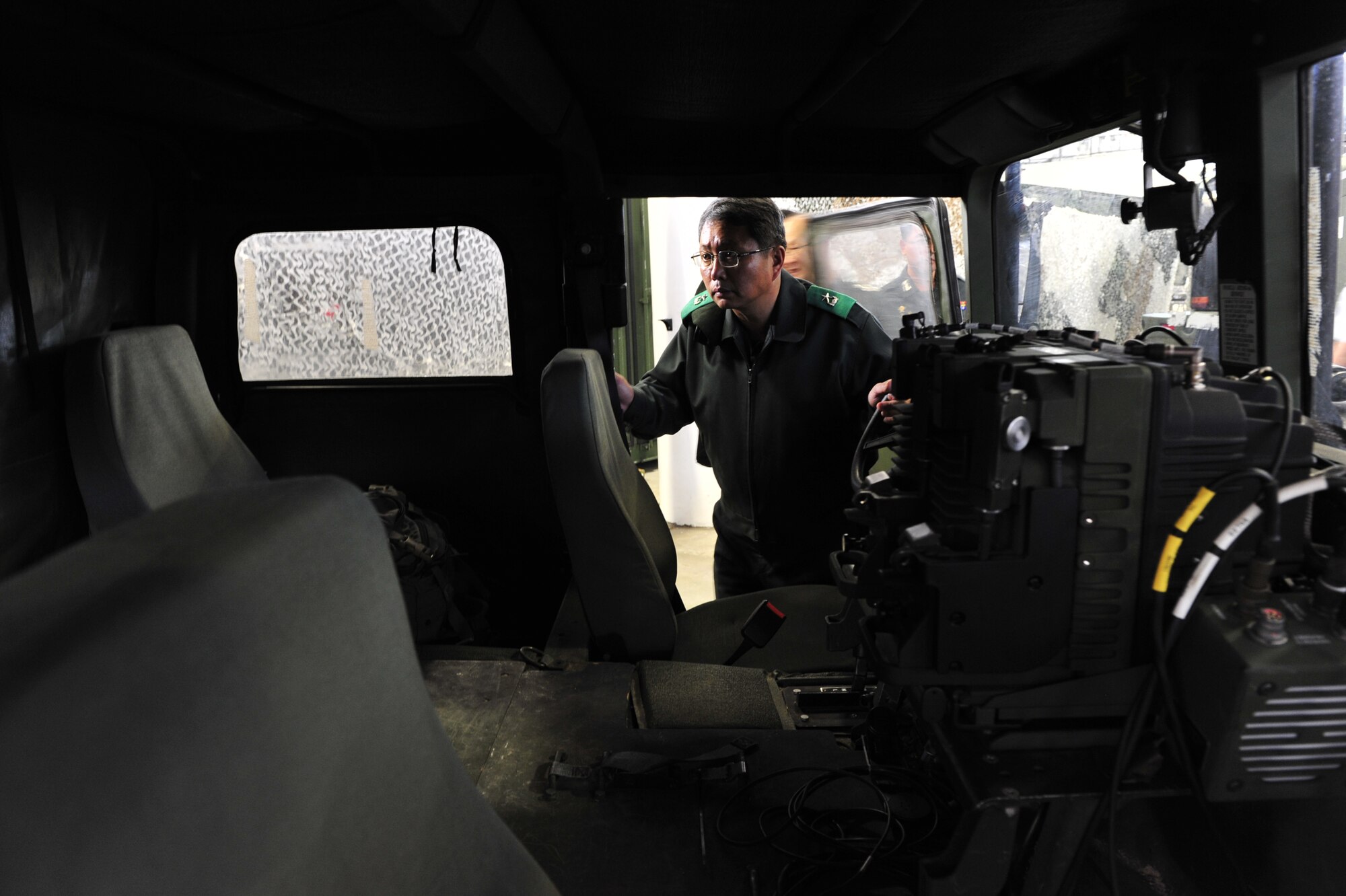 Brig. Gen. Gwi Chel Seo, commander of Transportation Command, Republic of Korea, inspects the inside of humvee used by an airfield assessment team during a tour of the 621st Contingency Response Wing's Global Reach Deployment Center here Nov. 14. General Seo and his staff spent the morning with the CRW, learning about Joint Task Force - Port Opening operations. (U.S. Air Force photo by Tech. Sgt. Parker Gyokeres/released)
