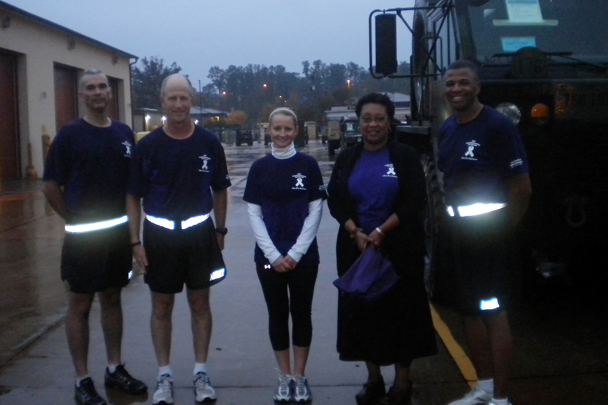 From left) Command Sgt. Maj. Zacarias Rivera, command sergeant major, 7th Sustainment Brigade (Provisional); Col. Steve Cherry, commander, 7th Sust. Bde. (Provisional); A.J. Brandt, family advocacy outreach manager; Marci Wright, director of transitions; and Lt. Col. Kenneth Williams, commander, 10th Transportation Battalion, following the battalion's two-mile run/walk for Domestic Violence awareness Nov. 4.