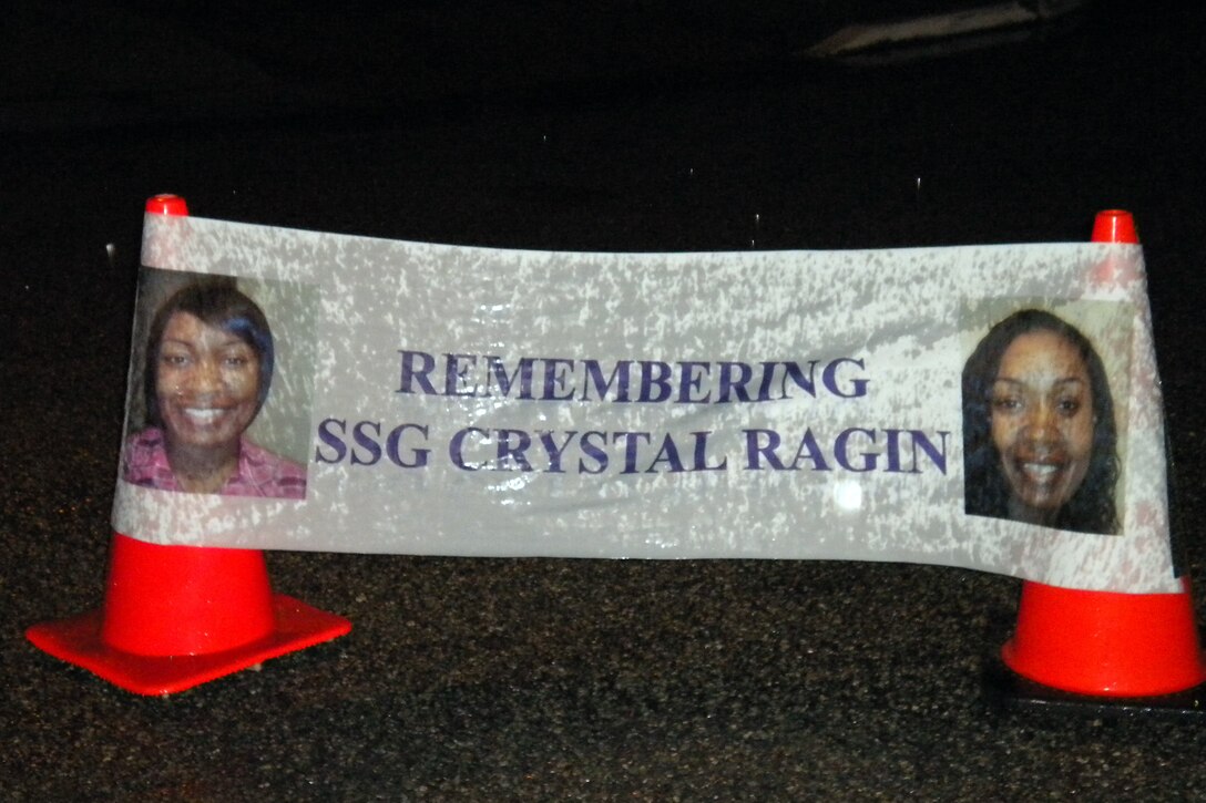 A banner displays photos of Staff Sgt. Crystal Ragin, who was assigned to the 10th Transportation Battalion, and whose recent death is being investigated as a potential domestic violence case. (U.S. Army photo by Warrant Officer Garnnette Mosley/RELEASED)