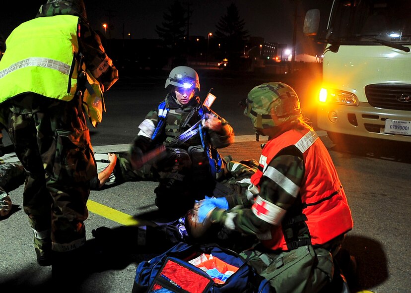 Members of the 51st Medical Group and Osan Fire Depratment respond to a simulated crash Nov. 17, 2011, during Beverly Bulldog 11-03, a pen-wide operational readiness exercise. The exercise allows Airmen to demonstrate their ability to complete the mission in a simulated hostile environment while executing their primarily duties. (U.S. Air Force photo/Senior Airman Adam Grant)