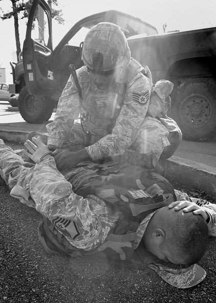 51st Security Forces members respond to an attempted robbery and shootout at Bldg 935, the finance office during Beverly Bulldog 11-03, a peninsula-wide operational readiness exercise, here, Nov. 14.  South Korea defenders are participating in a peninsula-wide operational readiness exercise (ORE), Beverly Bulldog 11-03.  Staff Sgt. Houston Pettway, performs a search of the suspect and takes him into custody. (U.S. Air Force photo/Staff Sgt. Daylena Gonzalez)