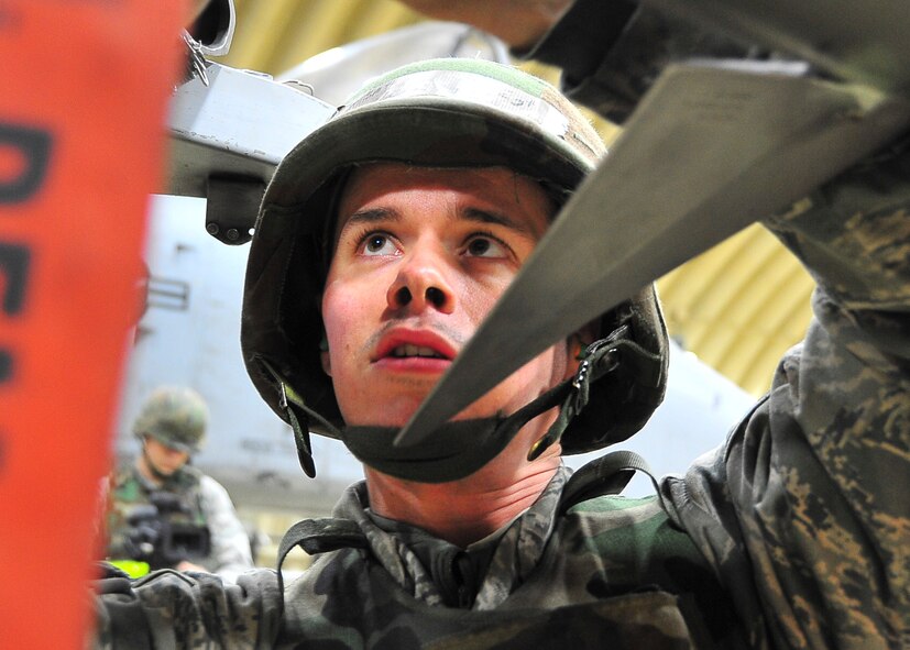 Senior Airman Douglas Howe, 51st Aircraft Maintenance Squadron weapons load crew member, ensures the proper placement of a live munitions during Beverly Bulldog 11-03, a peninsula-wide operational readiness exercise Nov. 14, 2011. Beverly Bulldog 11-03 scenarios test team Osan’s ability to defend the base and conduct daily operations in a combat environment. (U.S. Air Force photo/Senior Airman Adam Grant)