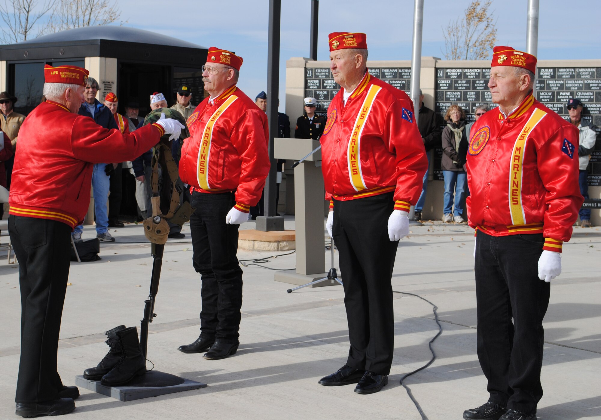 Members of the U.S. Marine Corps League set up a helmet and rifle memorial to display during the Veterans Day ceremony Nov. 11. The helmet and rifle memorial was first used to mark the place of a casualty, but it is now used to remember all of those who have fallen in honor of this country. (U.S. Air Force photo/Airman Cortney Paxton)