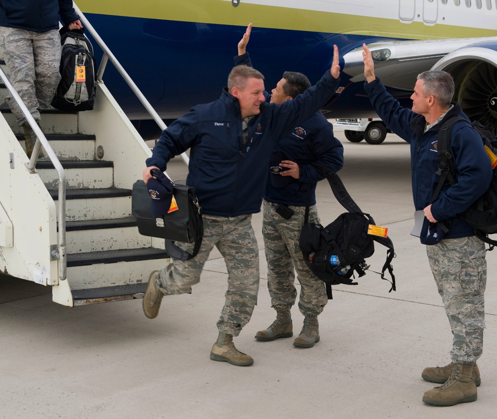 Col. David Bliesner, 341st Maintenance Group commander, high-five's Chief Master Sgt. Charles Anderson, 341st Missile Wing command chief, upon arrival at Holman Aviation Nov. 10. (U.S. Air Force photo/Beau Wade)