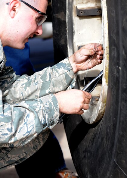 Airman 1st Class Michael Madigan, 317th Aircraft Maintenance Squadron, ties safety wiring onto a C-130 Hercules bearing retainer plate during training Nov. 16, 2011 at Dyess Air Force Base, Texas. Airmen from the 317 AMXS undergo additional training to stay updated on the C-130 H. (U.S. Air Force photo by Airman 1st Class Jonathan Stefanko/ Released)