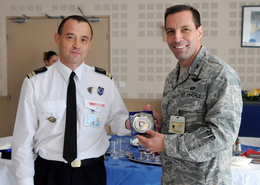 ISTRES, France – French Air Force Col. Marc Vinchon, Base Aérienne 125 commander, presents Col. Christopher Kulas, 100th Air Refueling Wing commander, with a vaisselle d'amitié – a small dish given as a token of friendship – adorned with the BA 125 patch during a luncheon at BA 125, Istres, France, Nov. 8, 2011.  Vinchon expressed that he was thankful for the 100th ARW’s help in providing support for the recent NATO air traffic treaty.  (U.S. Air Force photo/Staff Sgt. Tabitha M. Lee)