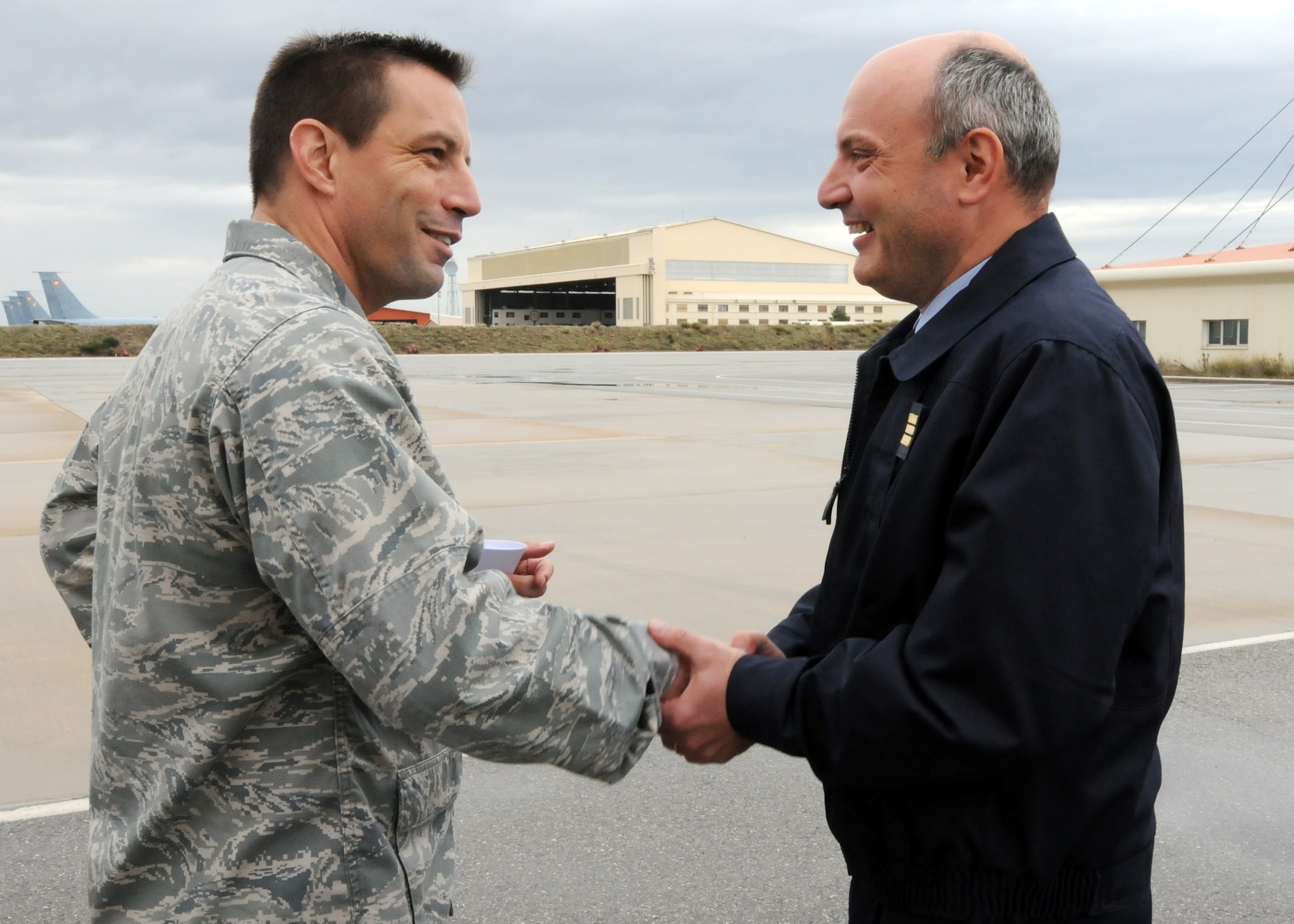 ISTRES, France – Col. Christopher Kulas, 100th Air Refueling Wing commander, coins French Air Force Capt. Gilles Allemand, primary French Air Force liaison to the 351st Expeditionary Air Refueling Wing, to show his appreciation for Allemand’s contribution during the 351st Expeditionary Air Refueling Wing’s stay at Base Aérienne 125, Istres, France, Nov. 8, 2011.  Allemand was assigned as primary liaison to the advanced echelon team when they arrived on April 8, 2011, and remained a crucial link to the host nation counterparts throughout the deployment in support of Operation Unified Protector. (U.S. Air Force photo/Staff Sgt. Tabitha M. Lee) 