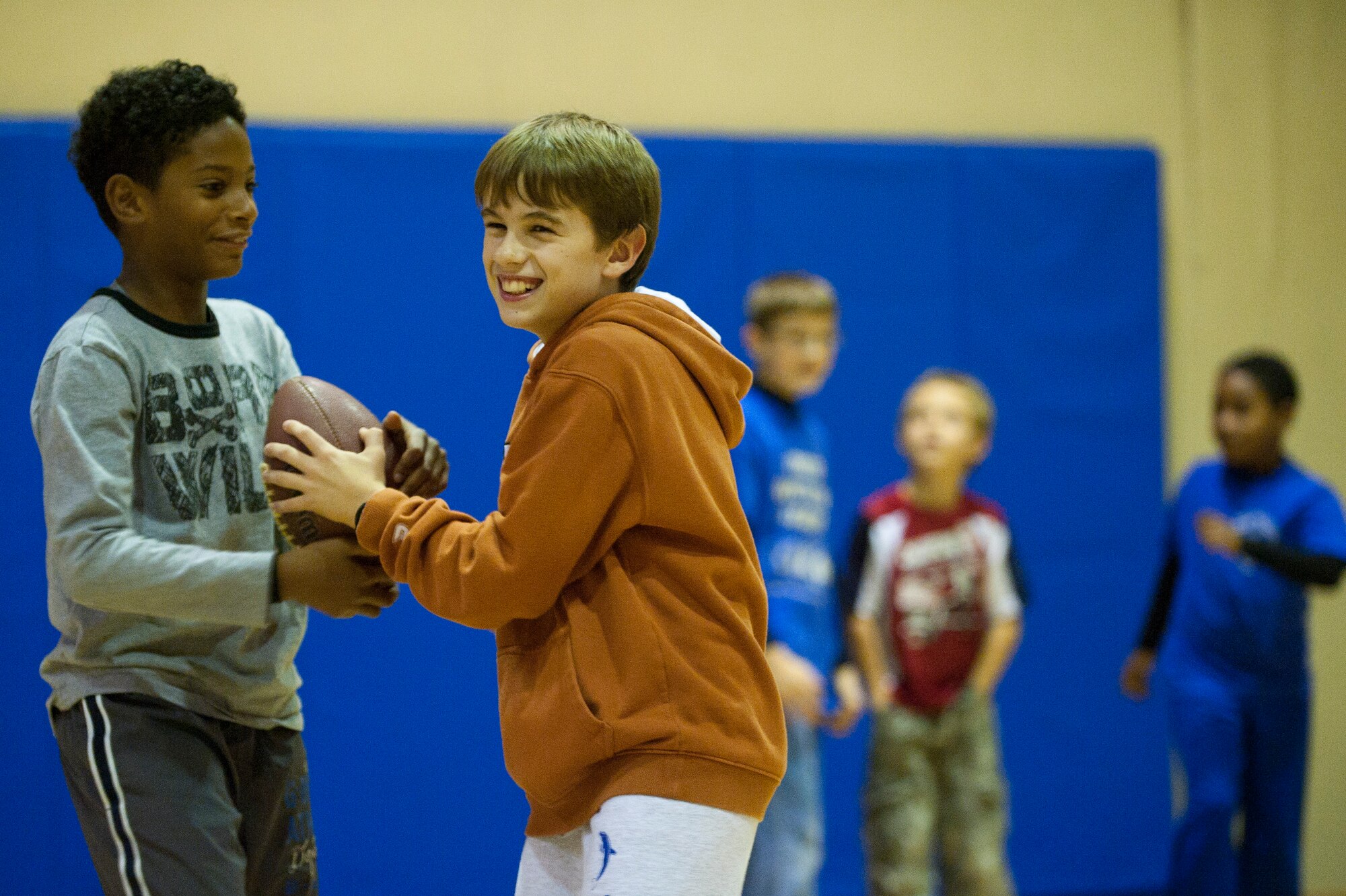 Children joke before another drill during a football mini-camp Nov. 16, 2011, at Incirlik Air Base, Turkey. The camp, hosted by the youth center, was held Nov. 14-18 in lieu of the youth football season and featured instruction on a variety of techniques for beginning players. (U.S. Air Force photo by Tech. Sgt. Michael B. Keller)