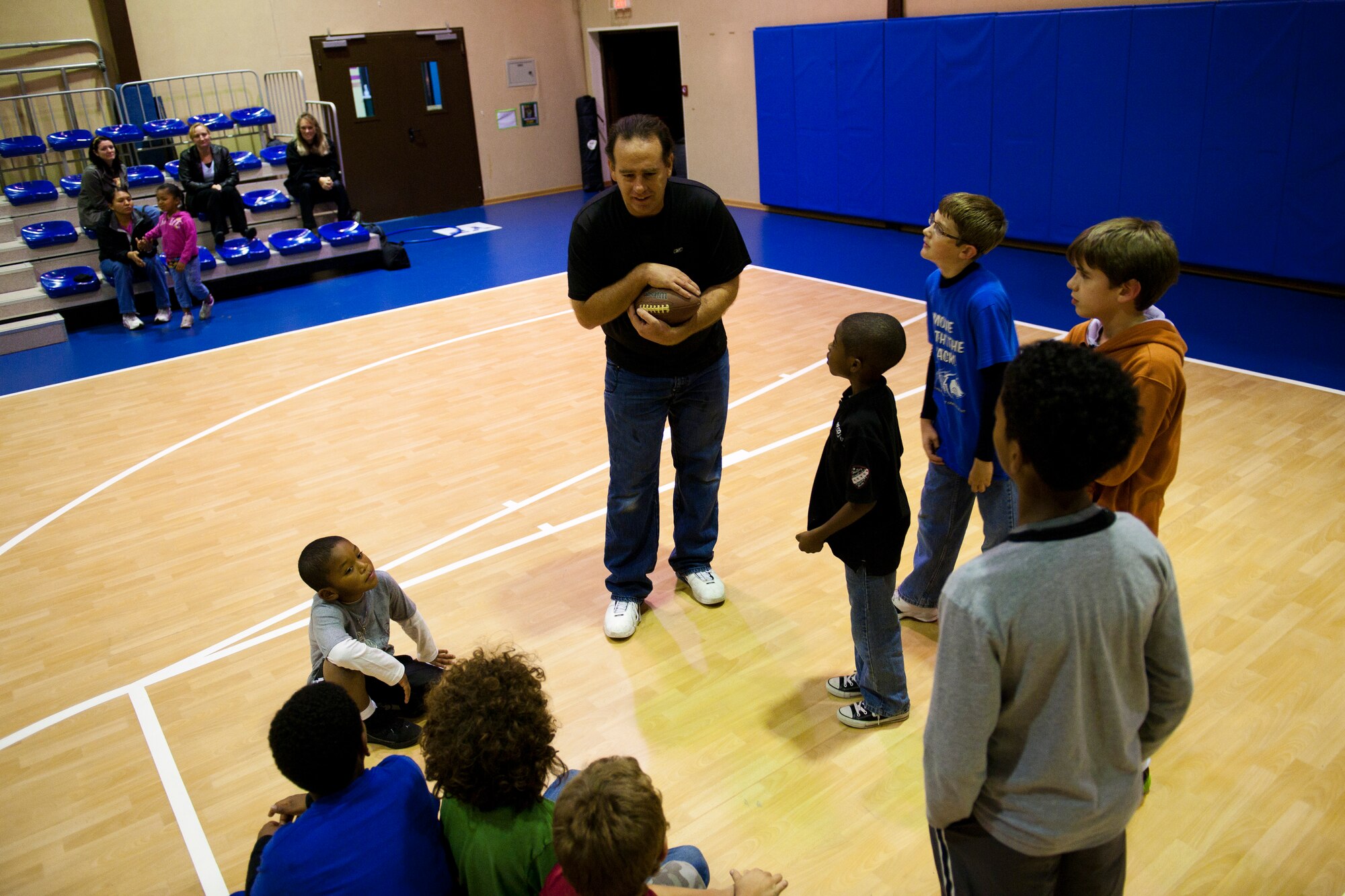 Marcus Grothues, 39th Force Support Squadron youth program specialist, gives instructions to children participating in a football mini-camp Nov. 16, 2011, at Incirlik Air Base, Turkey. The camp, hosted by the youth center, was held Nov. 14-18 in lieu of the youth football season and featured instruction on a variety of techniques for beginning players. (U.S. Air Force photo by Tech. Sgt. Michael B. Keller)