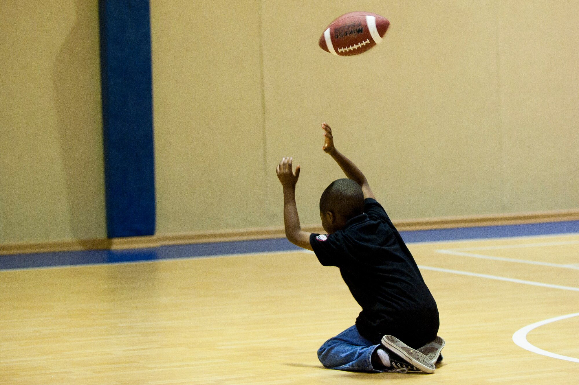 A child reaches for a pass during a football mini-camp Nov. 16, 2011, at Incirlik Air Base, Turkey. The camp, hosted by the youth center, was held Nov. 14-18 in lieu of the youth football season and featured instruction on a variety of techniques for beginning players. (U.S. Air Force photo by Tech. Sgt. Michael B. Keller)