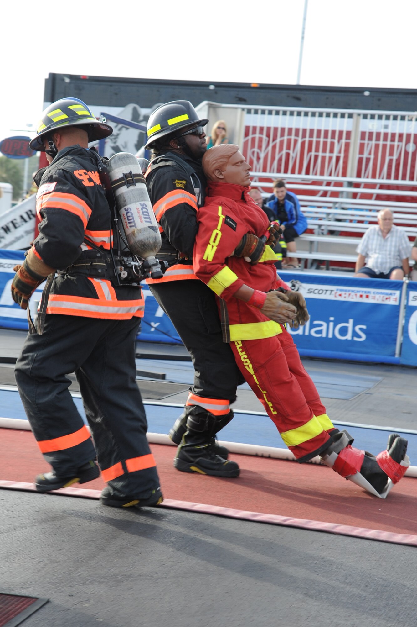Marcus Shepard, 4th Civil Engineer Squadron (CES) lead firefighter, drags a dummy out of a simulated fire while being motivated by Staff Sgt. Skipper Valentin-Cruzado, 4 CES fire inspector, during the Scott World Firefighter Combat Challenge in Myrtle Beach, S.C., Nov. 15, 2011. Shepard carried the 175-pound dummy 106 feet to the finish line. Sheppard hails from Goldsboro, N.C. and Valentin hails from Puerto Rico. (U.S. Air Force photo by Senior Airman Whitney Stanfield)