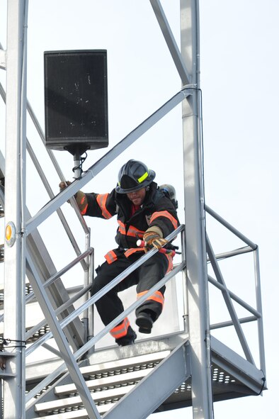Robert Columbus, 4th Civil Engineer Squadron firefighter driver operator, sprints down five flights of stairs during the Scott World Firefighter Combat Challenge in Myrtle Beach, S.C., Nov. 15, 2011. The challenge consisted of five tasks to include climbing the five story tower, hoisting, chopping, dragging hoses and rescuing a life-sized 175 pound dummy while competing for the best time of over 150 teams. Columbus hails from Pittsburgh. (U.S. Air Force photo by Senior Airman Whitney Stanfield)