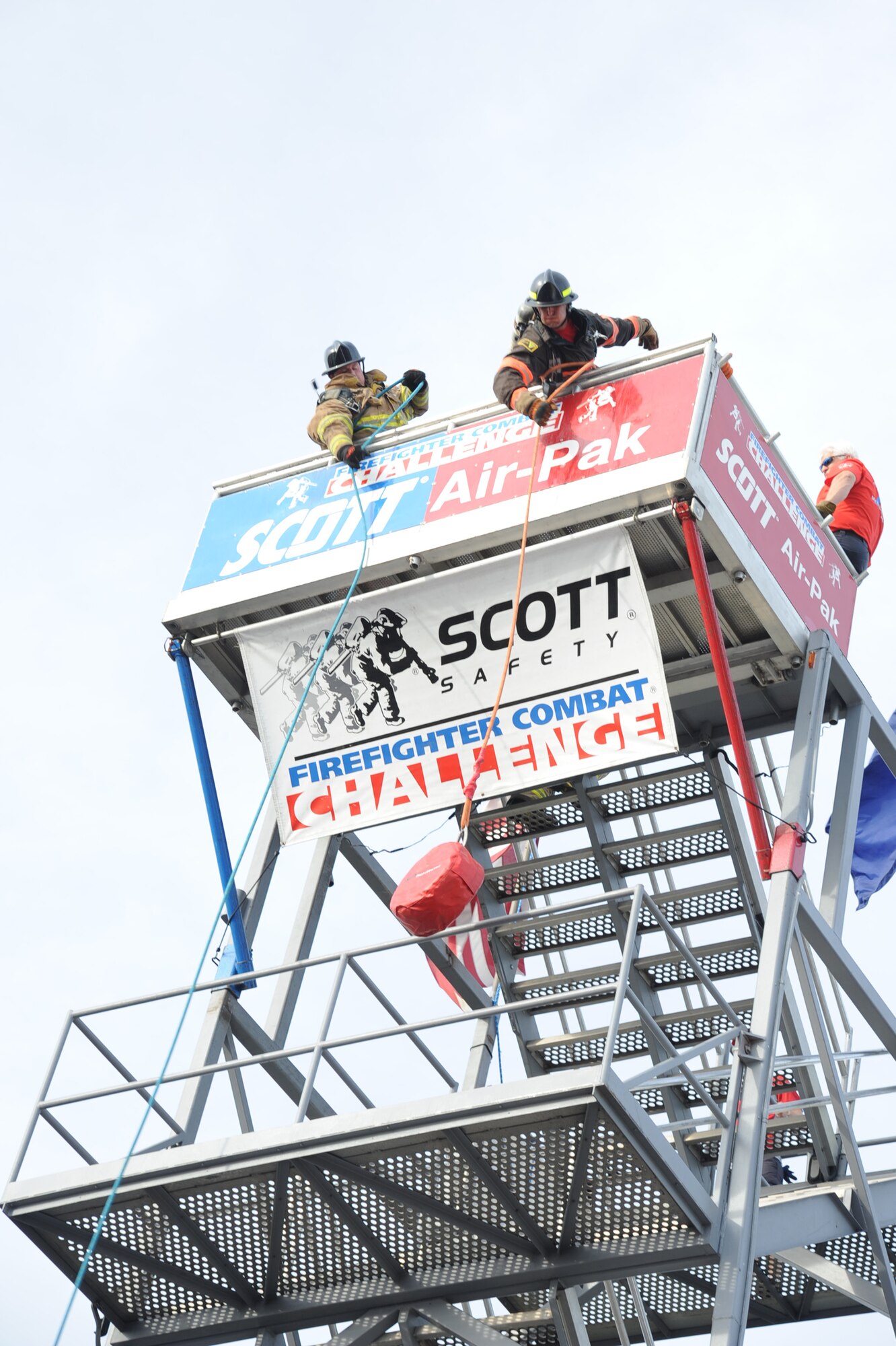 Staff Sgt. Aaron Shields (right,) 4th Civil Engineer Squadron firefighter crew chief, hoists a hose while participating in the Scott World Firefighter Combat Challenge in Myrtle Beach, S.C., Nov. 15, 2011. The firefighters were required to hoist a hose up a tower during a relay race. Shields is a native of Cedar Rapids, Iowa. (U.S. Air Force photo by Senior Airman Whitney Stanfield)