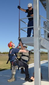 Jimmy Sibley, Wright Rescue Solutions Inc., instructs Randolph and Universal City, Texas fire fighters in the correct to perform a high angle and confined space rescue Nov. 16 through a week-long course held on Randolph Air Force Base.  (U.S. Air Force Photo by Don Lindsey)