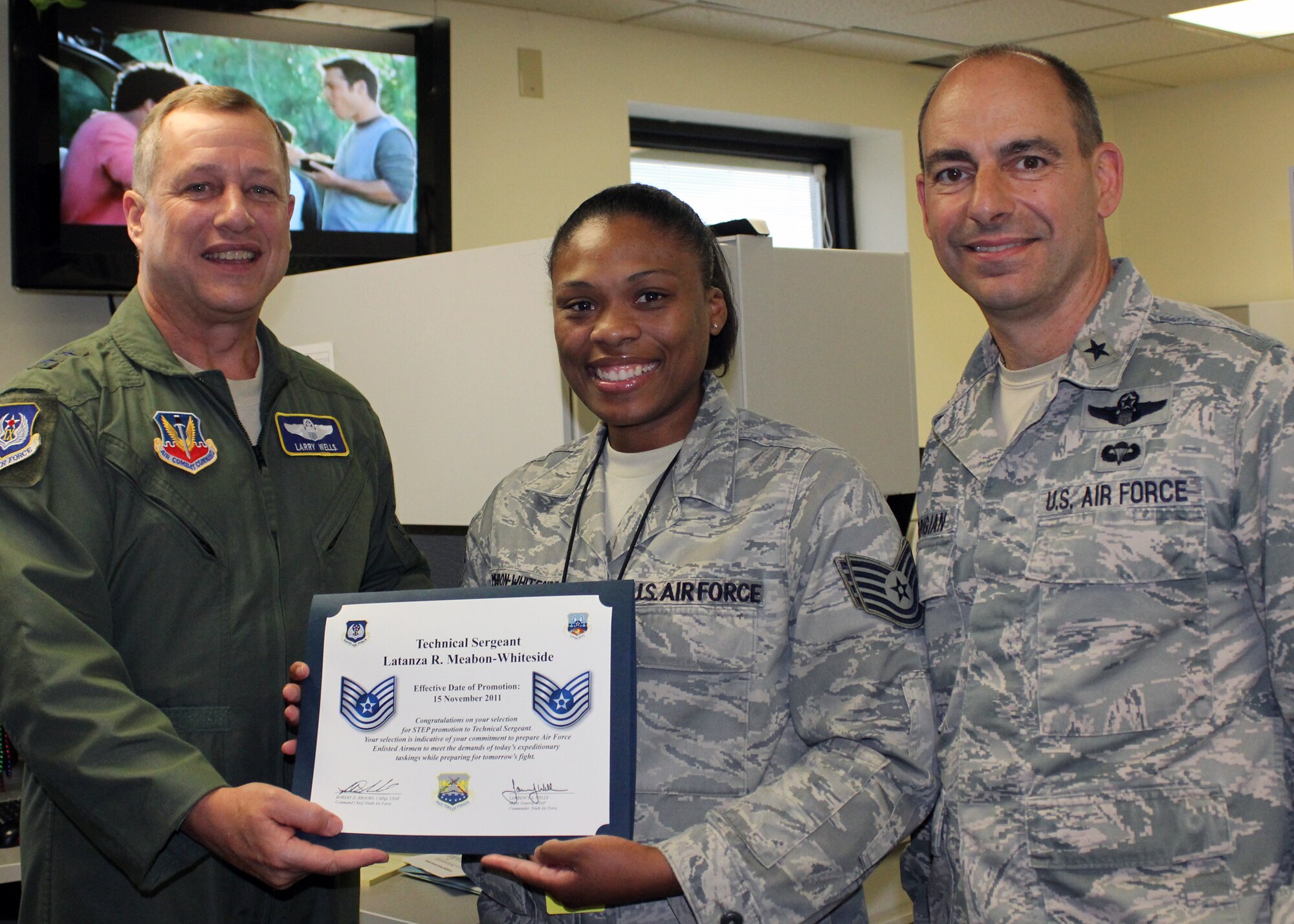 SHAW AIR FORCE BASE, S.C. – Tech. Sgt. Latanza Meabon-Whiteside (center), 100th Logistic Readiness Squadron, was STEP-promoted from staff sergeant to technical sergeant under the Stripes for Excellent Performers program Nov. 25, 2011. Maj. Gen. Lawrence Wells (left), 9th Air Force commander, and Brig. Gen. Jeffrey Harrigian, Air Force Central Command deputy commander, surprised the sergeant at her deployed location with the new stripe. Meabon-Whiteside, 100th Air Refueling Wing Air Expeditionary Force reporting tool coordinator, is deployed to Shaw Air Force Base, S.C., in AFCENT’s logistics (A4) division. Chief Master Sgt. Robert Brooks (not pictured here), 9th AF command chief, was also present to recognize Meabon-Whiteside’s STEP promotion and presented her with the certificate of promotion.  (Courtesy photo)