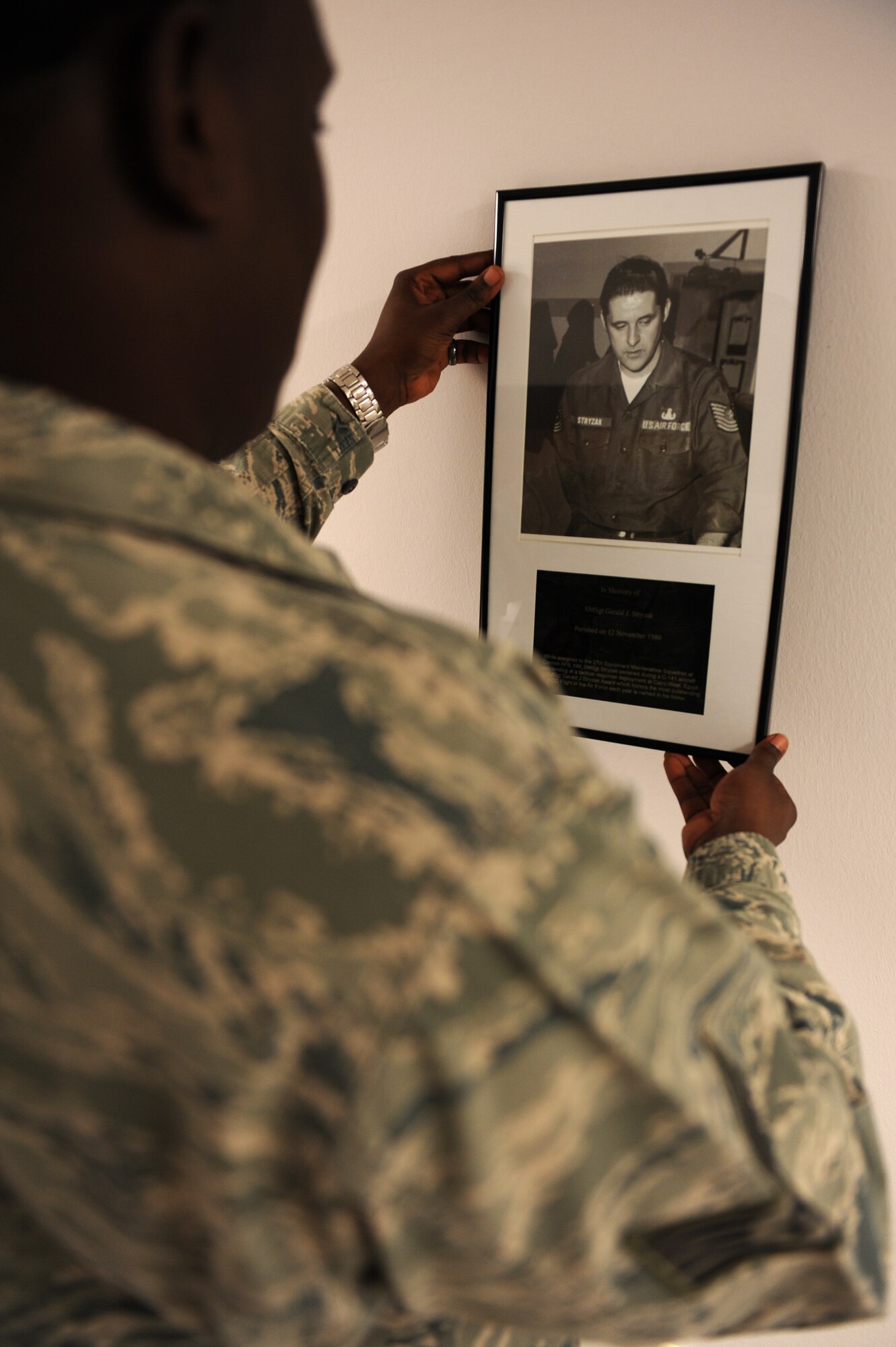 SPANGDAHLEM AIR BASE, Germany – Staff Sgt. Jevon King, 52nd Civil Engineer Squadron unit deployment manager, places a plaque on the U.S. Air Force Civil Engineer Hallway of Heroes in Bldg. 119 here Nov. 9. CES created the hallway to honor Air Force engineers who died during combat operations from Vietnam to today’s fight. (U.S. Air Force photo/Airman 1st Class Matthew B. Fredericks)