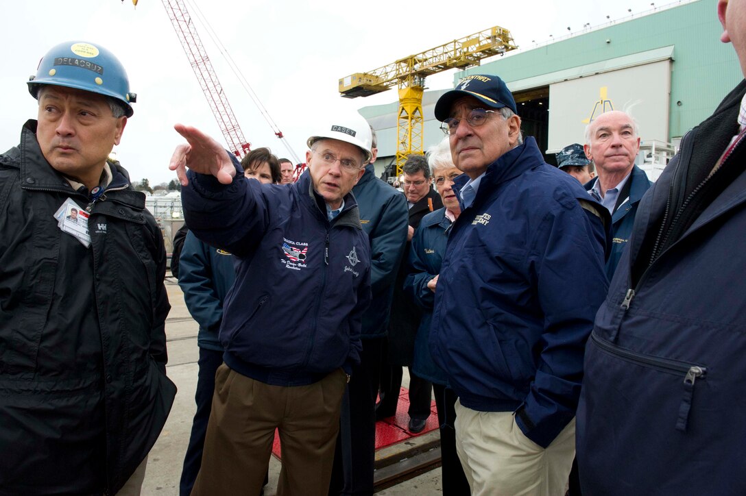 Defense Secretary Leon E. Panetta speaks with John Casey, president of General Dynamics Electric Boat, in front of the Virginia-class attack submarine to be commissioned the USS Mississippi in Groton, Conn., Nov. 17, 2011.