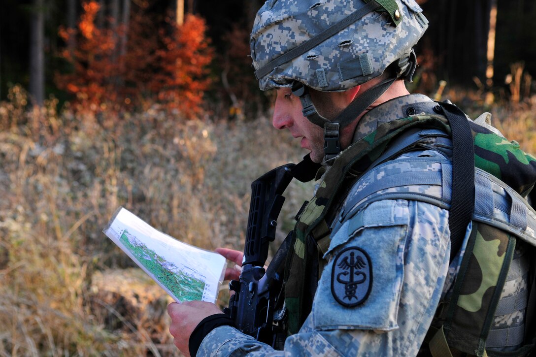 U.S. Army Cpt. Jeremy Brooks navigates to a point during the night-to-day land navigation course as a part of the U.S. Army Europe Best Junior Officer Competition on U.S. Army Garrison Grafenwoehr in Germany, Nov. 16, 2011. Brooks is assigned to the Landstuhl Regional Medical Center.