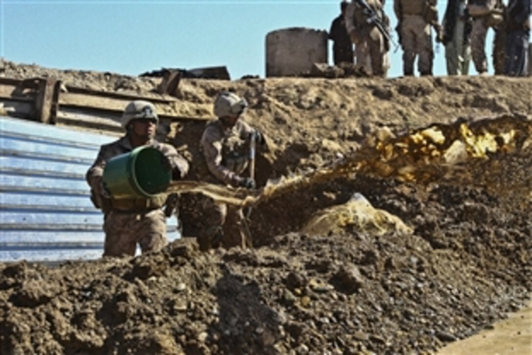 U.S. Marine Cpl. Samuel Escutia Jr., empties water from a culvert  in the Marjah district of Afghanistan's Helmand province, Nov. 12, 2011. Escutia is a combat engineer assigned to Alpha Company, Combat Logisitics Battalion 1. U.S. Marines are currently repairing the support structure on a bridge located at a major intersection that connects Marjah and Nawa districts. The bridge receives heavy foot and vehicle traffic due to the local bazaar, as well as Afghan and coalition military convoys.