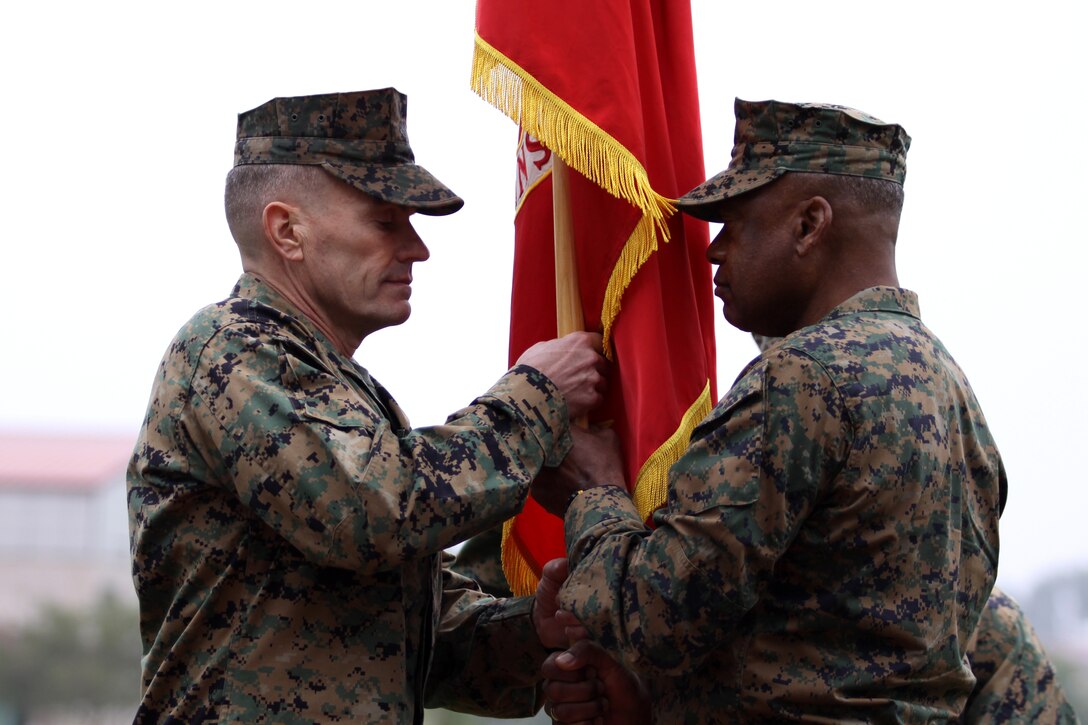 Maj. Gen. Anthony L. Jackson (right) passes off the colors to Brig. Gen. Vincent A. Coglianese during the Marine Corps Installation-West Commanding General change of command ceremony at Camp Pendleton, Nov. 18.