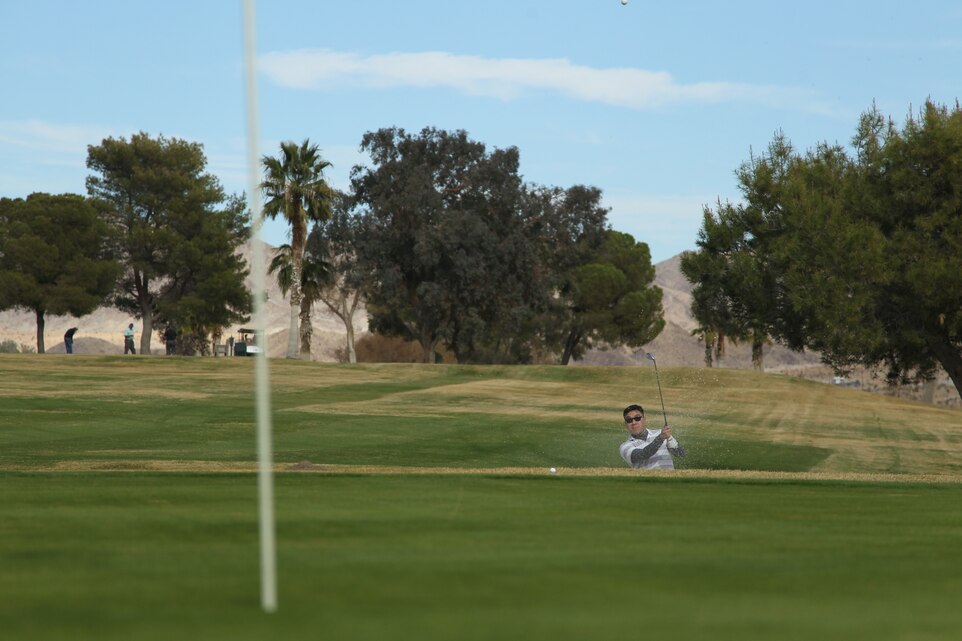 David Wu, a first time golfer, chips the ball out of a sand trap during the Annual Turkey Shoot, at Desert Winds Golf Course Nov. 18, 2011.