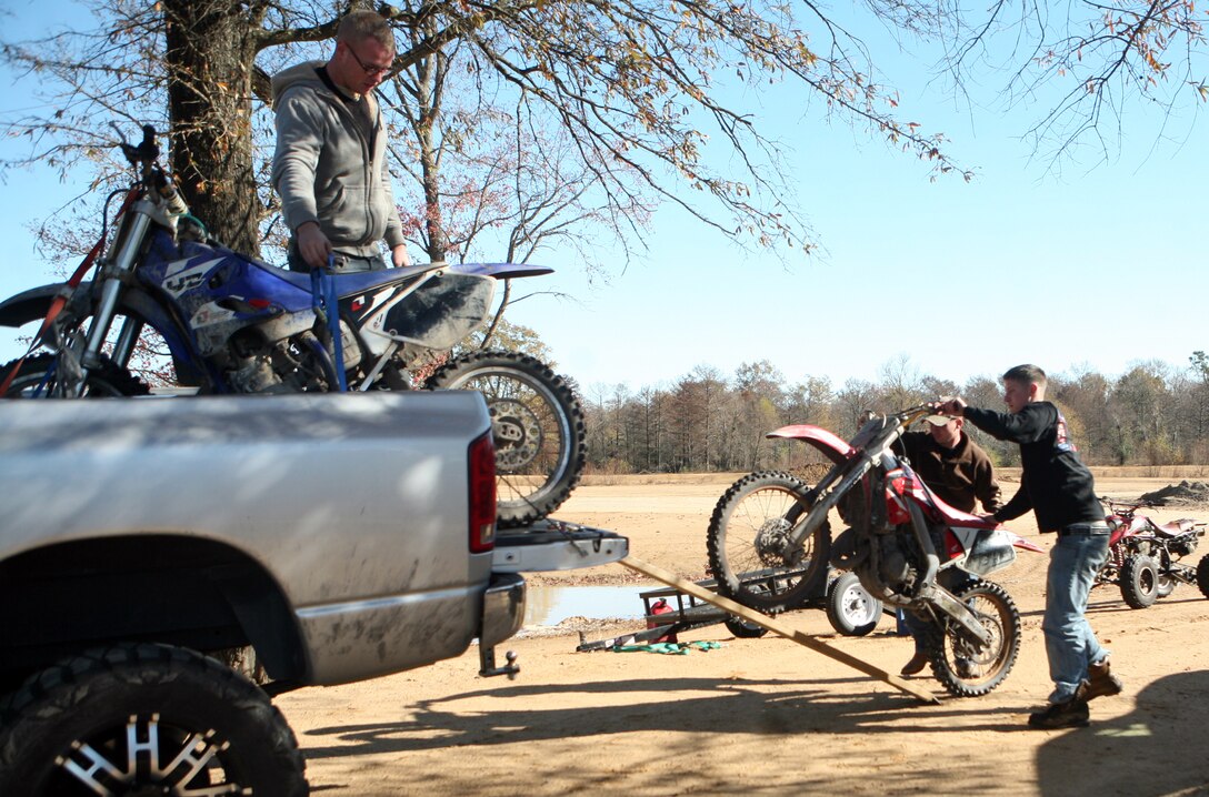 Marines with the 2nd Marine Logistics Group unload their dirt bikes before the off-road quarterly ride at Busco Beach in Goldsboro, N.C., November 18, 2011. The intent of the training was to facilitate off-road training for Marines and sailors with the 2nd MLG. The training was given by more experienced riders who possessed the knowledge junior riders could benefit from. (U.S. Marine Corps photo by. Pfc. Franklin E. Mercado)