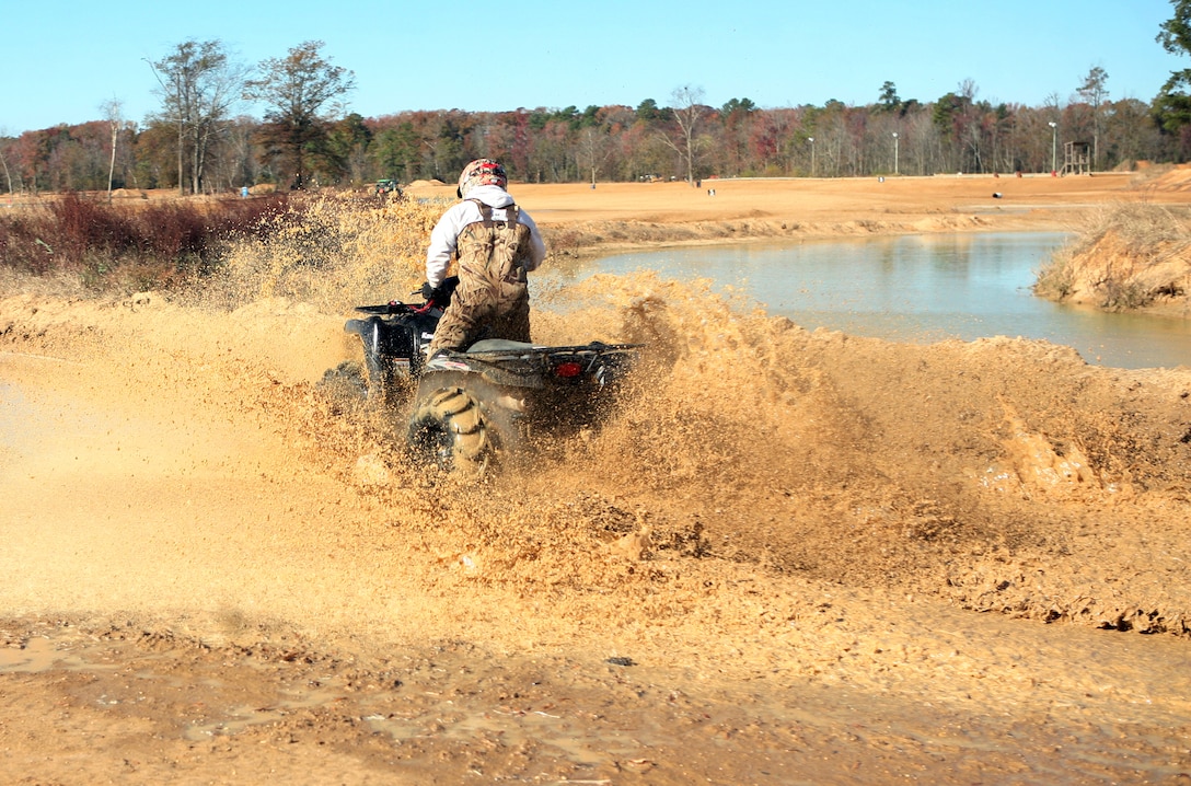 A Marine with the 2nd Marine Logistics Group rides through mud during the off-road quarterly ride at Busco Beach in Goldsboro, N.C., November 18, 2011. The intent of the training was to facilitate off-road training for Marines and sailors with the 2nd MLG. The training was given by more experienced riders who possessed the knowledge junior riders could benefit from. (U.S. Marine Corps photo by Pfc. Franklin E. Mercado)