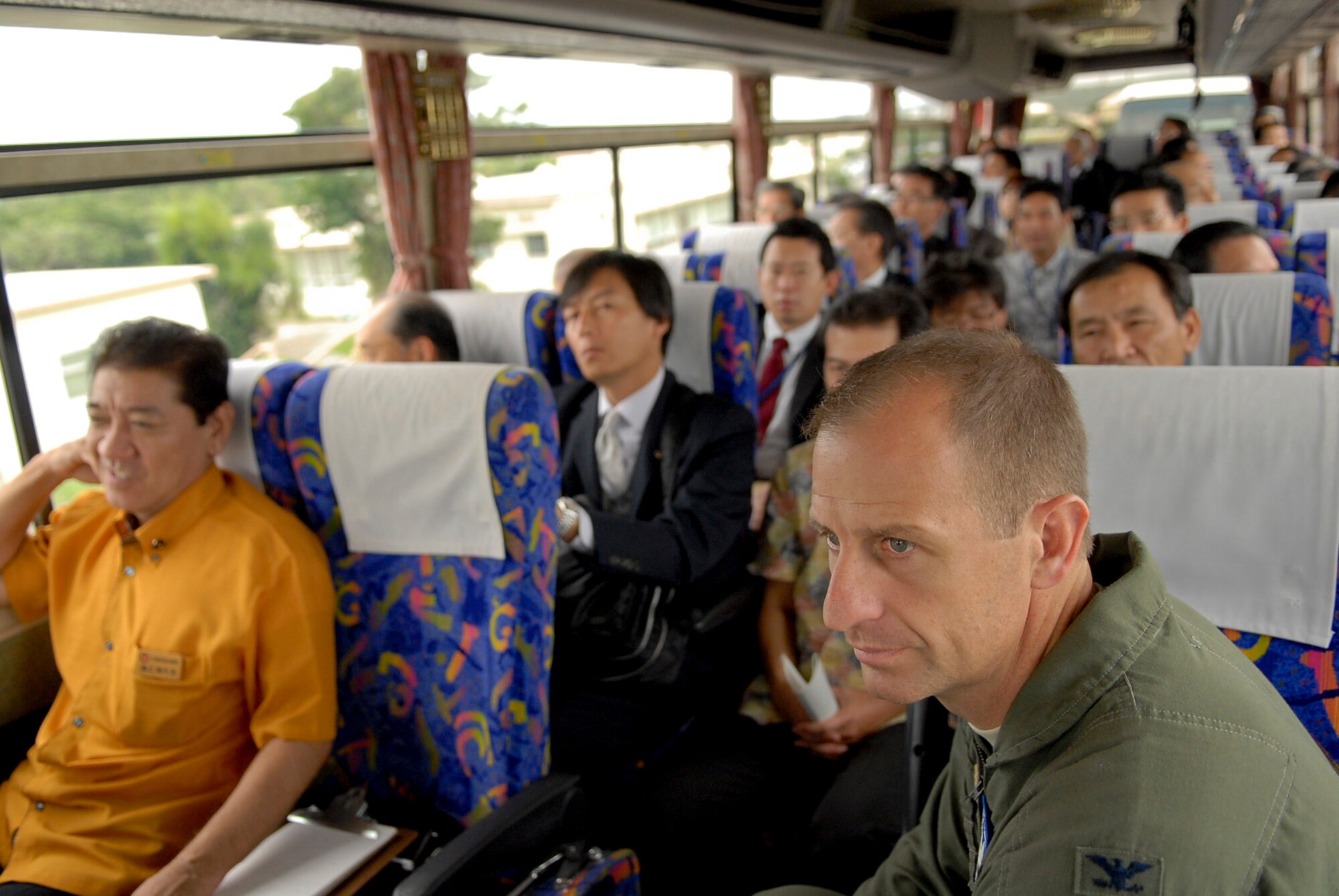 U.S. Air Force Col. Corey Martin, 18th Wing vice commander, accompanies members of the Liaison Council of Defense-related Kyushu-Okinawa Prefectural and City Assemblies, a pro- United States group, on a tour of Kadena Air Base, Japan, Nov. 17, 2011. The tour gave council members a view of the flight line and also a glimpse of everyday life, including housing, the Commissary and the Exchange. (U.S. Air Force photo by Airman 1st Class Tara A. Williamson/released)