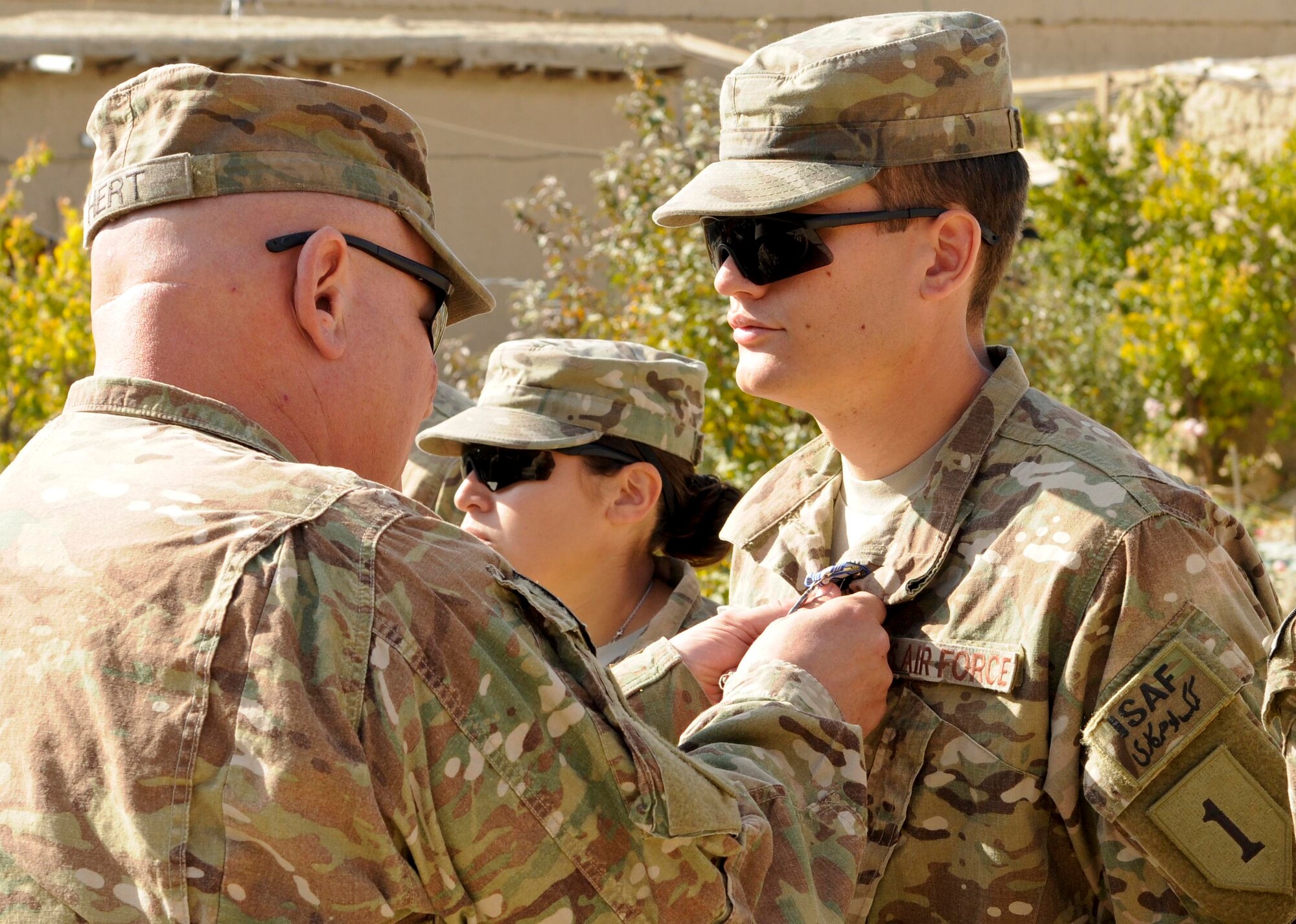 Senior Airman Gerrett Cook, Provincial Reconstruction Team Paktya
medic, from Tracy City, Tenn., receives an Air Force Achievement Medal
for his actions in saving the life of a Soldier in July on Forward Operating
Base Gardez, Paktya Province, Afghanistan, Nov. 4. Cook, deployed from
the 45th Medical Operations Squadron, Patrick AFB, Fla., is one of four
medical personnel assigned to the PRT, responsible for the well-being of
more than 75 Soldiers and Airmen. (U.S. Air Force photo/Senior Airman Wesley Farnsworth)