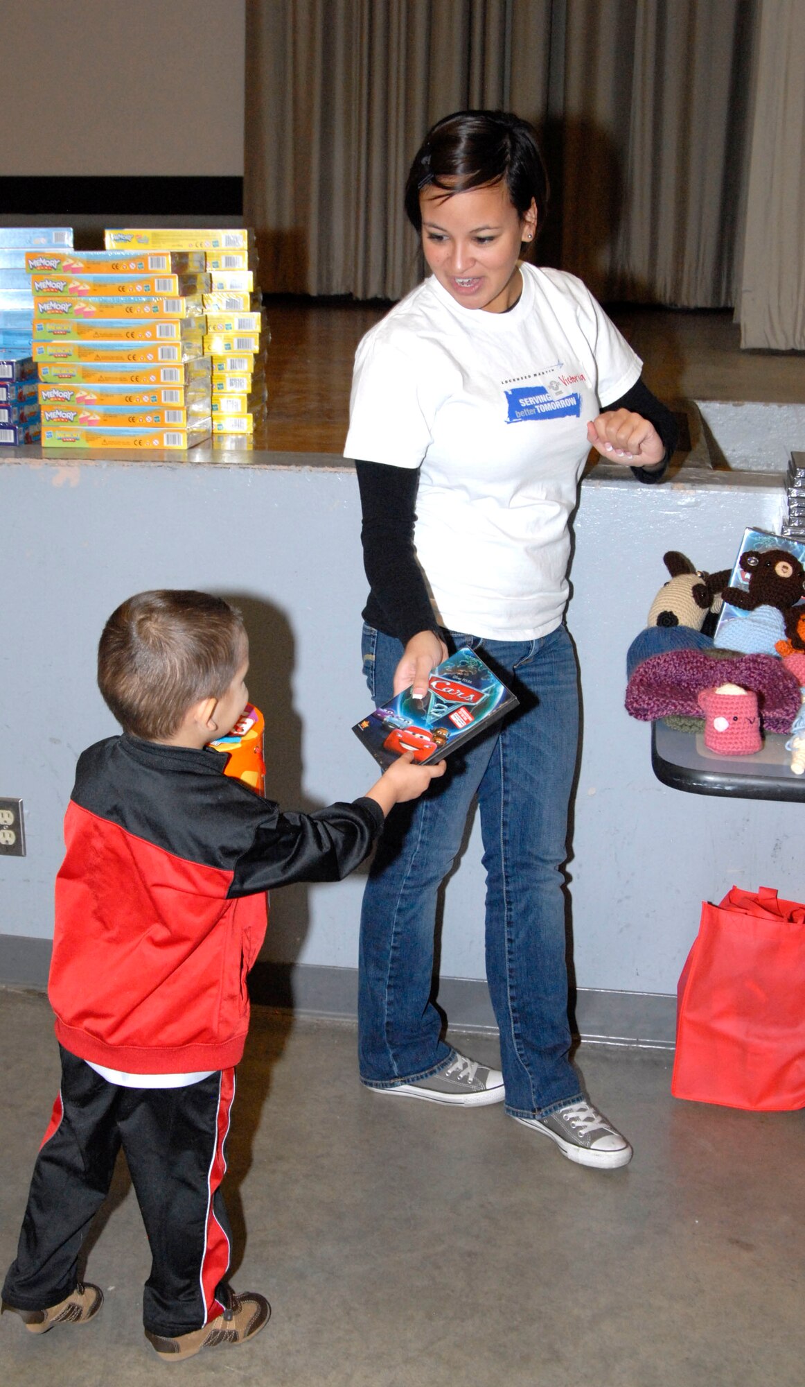 A young Air Force family member receives his copy of "Cars 2." The family film was part of a total Thanksgiving package offered to members of Team Edwards here Nov. 9. (U.S. Air Force Photo by Laura Mowry)