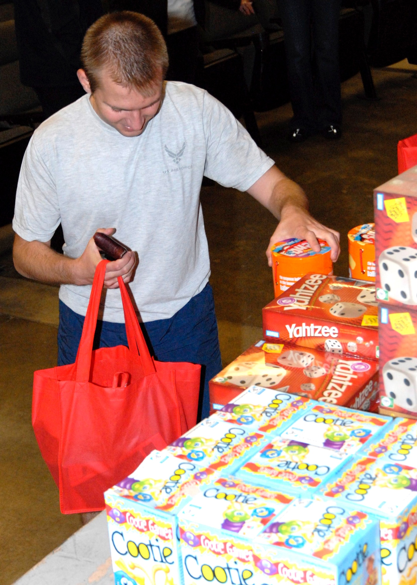 An Airman picks out a family game to share with his loved ones on Thanksgiving courtesy of Operation Homefront Southern California, and their partners Lockheed Martin and the Edwards First Sergeants Council, at the "Thanks for Giving Edwards AFB" event here Nov. 9. (U.S. Air Force Photo by Laura Mowry) 