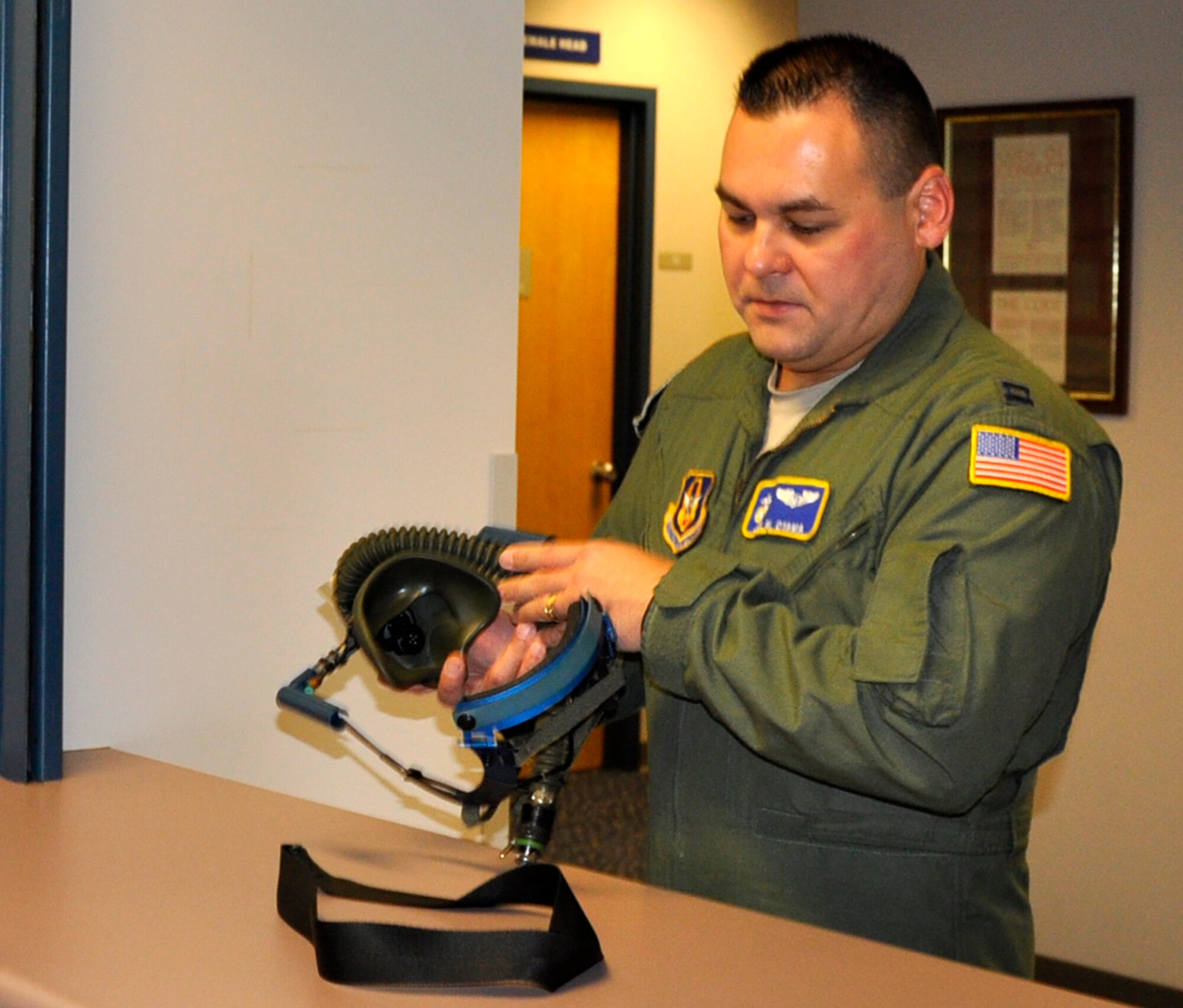 Capt. Joel Oyama, 446th Aeromedical Evacuation Squadron flight nurse, checks out a Quick Don oxygen mask at the Aviation Survival Training Center, Naval base Whidbey Island, Wash., Nov. 9, 2011. ASTC is where McChord Field aircrew members currently receive their high-altitude chamber refresher training. (U.S. Air Force photo/Master Sgt. Jake Chappelle)