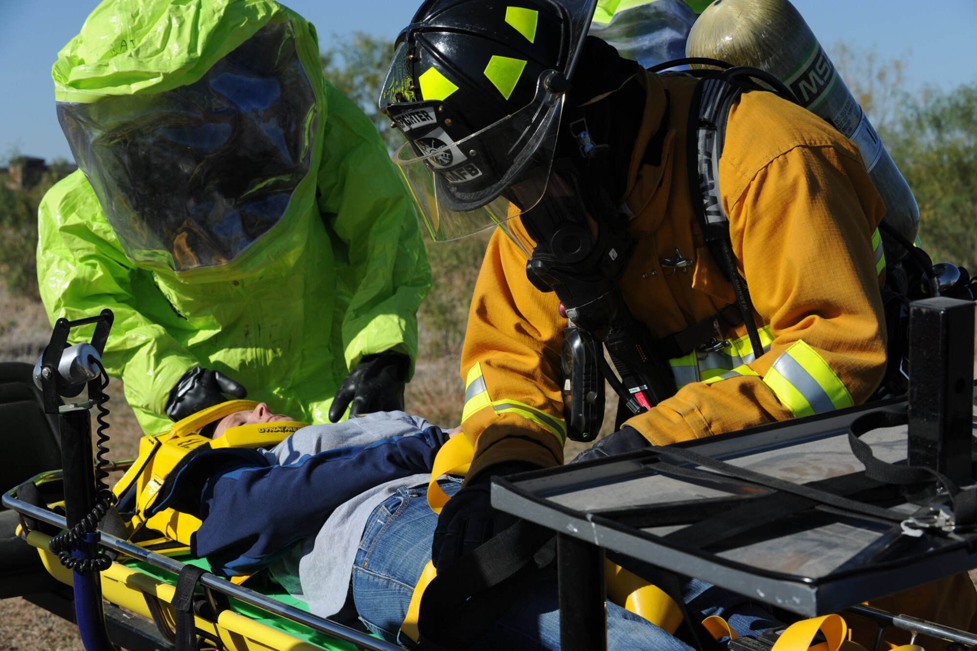 GOODFELLOW AIR FORCE BASE, Texas -- Firefighters, from the 17th Civil Engineer Squadron, prepare the simulated pilot for helicopter evacuation during Exercise Scarlet Hawk 11-12, Nov. 16. Exercises are conducted to ensure base personnel are prepared to respond to any contingency. (U.S. Air Force photo/Staff Sgt. Laura R. McFarlane)