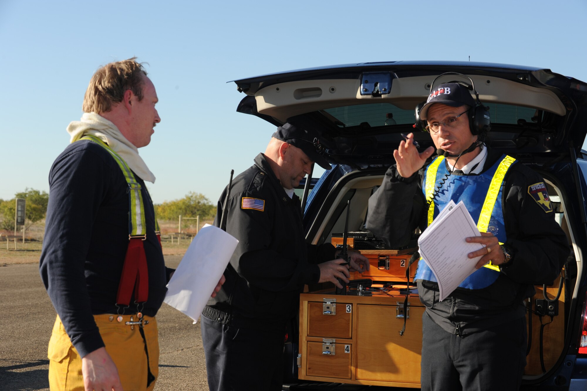 GOODFELLOW AIR FORCE BASE, Texas -- Firefighter Paul Bourne is briefed by Fire Chief Richard Alter on the current situation during Exercise Scarlet Hawk 11-12, Nov. 16, while Assistant Chief Darrell Drost monitors exercise communications. All three are members of the 17th Civil Engineer Squadron. (U.S. Air Force photo/Staff Sgt. Laura R. McFarlane)