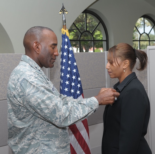 Maj. Gen. A.J. Stewart, Air Force Personnel Center commander, presents Vonda Ware with the Secretary of Defense Medal for the Global War on Terrorism.  Ware is a community readiness analyst assigned to AFPC’s Warrior and Family Operations Center.  She volunteered to deploy to Southwest Asia in November 2009. (Air Force photo/Joel Martinez)