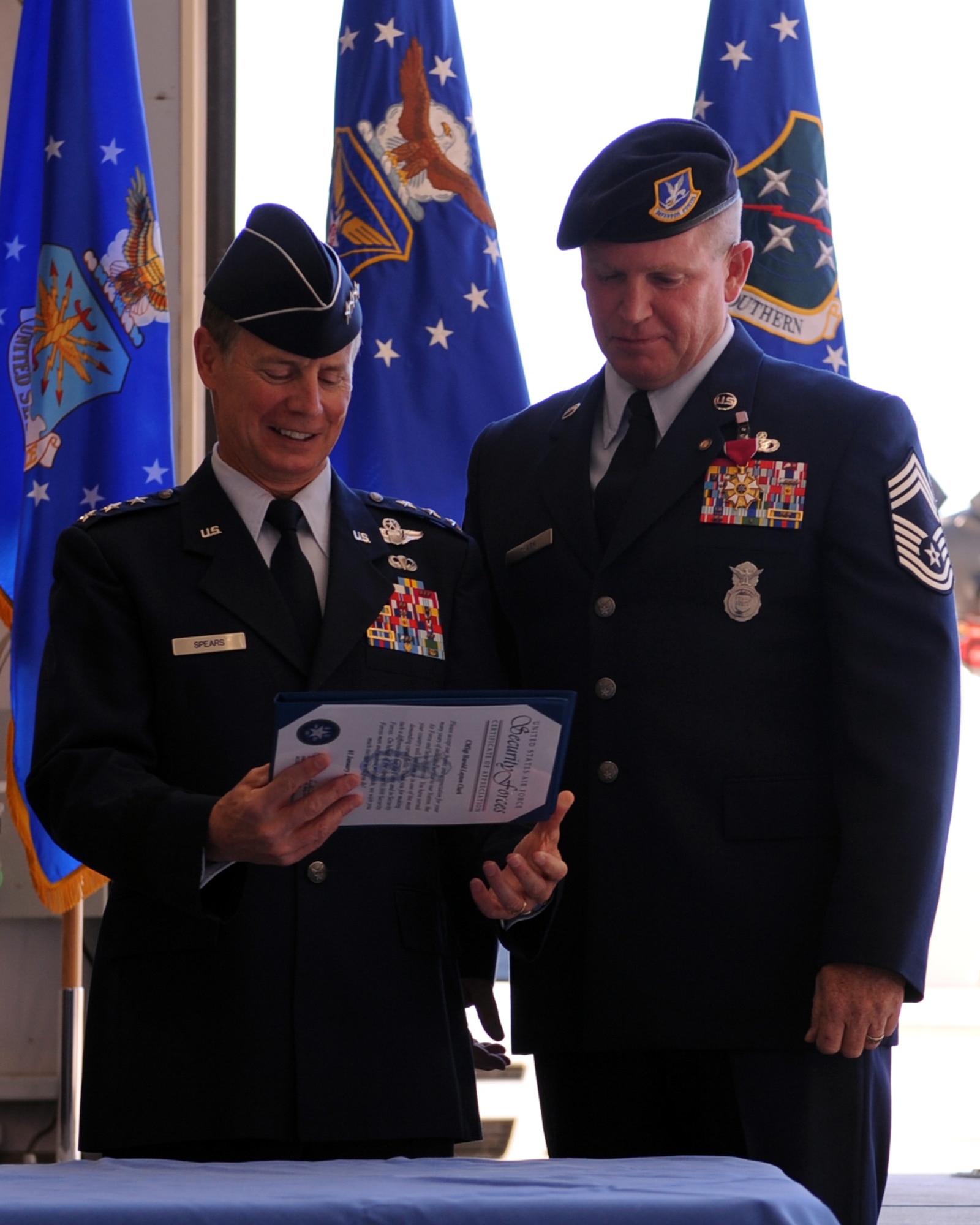 U.S. Air Force retired, Lt. Gen. Glenn Spears, presents Chief Master Sgt. Harold Clark, 12th Air Force (Air Forces Southern), command chief, with an award during the Chief’s retirement ceremony on Davis-Monthan Air Force Base, Ariz., Nov. 18, 2011. (U.S. Air Force photo by Airman 1st Class Christine Griffiths/Released) 