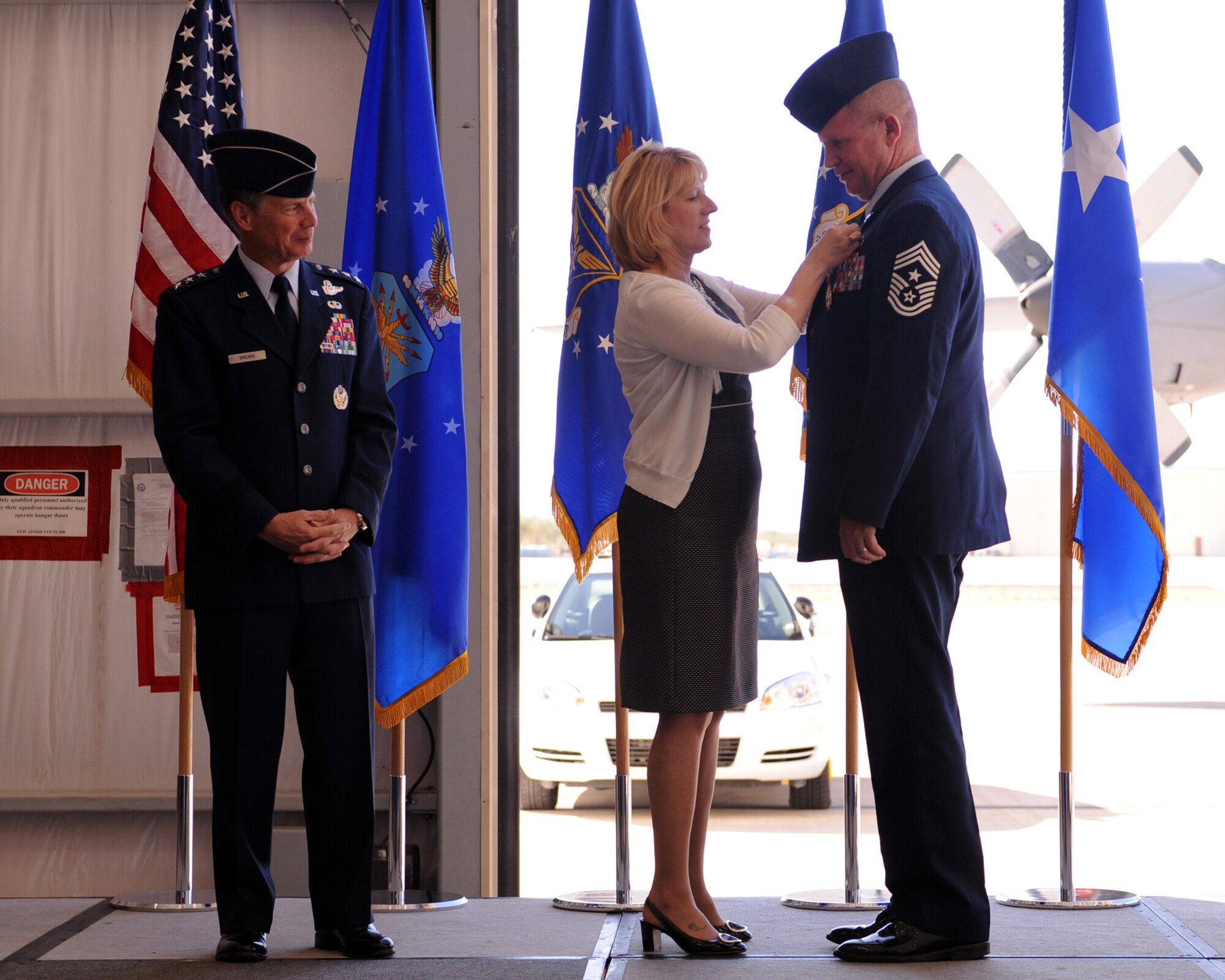 U.S. Air Force Chief Master Sgt. Harold Clark, 12th Air Force (Air Forces Southern) command chief, receives his retirement pin from his wife, Teresa, at during his retirement ceremony on Davis-Monthan Air Force Base, Ariz., Nov 18, 2011. (U.S. Air Force photo by Airman 1st Class Christine Griffiths/Released) 
