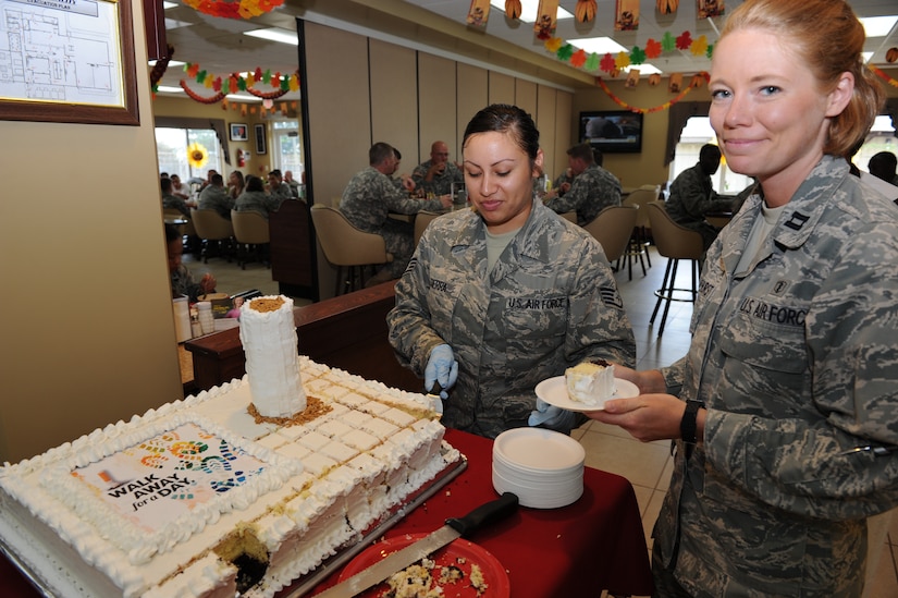 Staff Sgt. Deanna Sierra, a Medical Element diet technician, and Capt. Katie Whitehurst, the officer-in-charge of MEDEL’s preventive medicine, cut the cake in honor of the Great American Smoke-out's “Walk Away for a Day” in the dining facility Nov. 17 at Soto Cano Air Base, Honduars.  (U.S. Air Force photo/Tech. Sgt. Matthew McGovern)