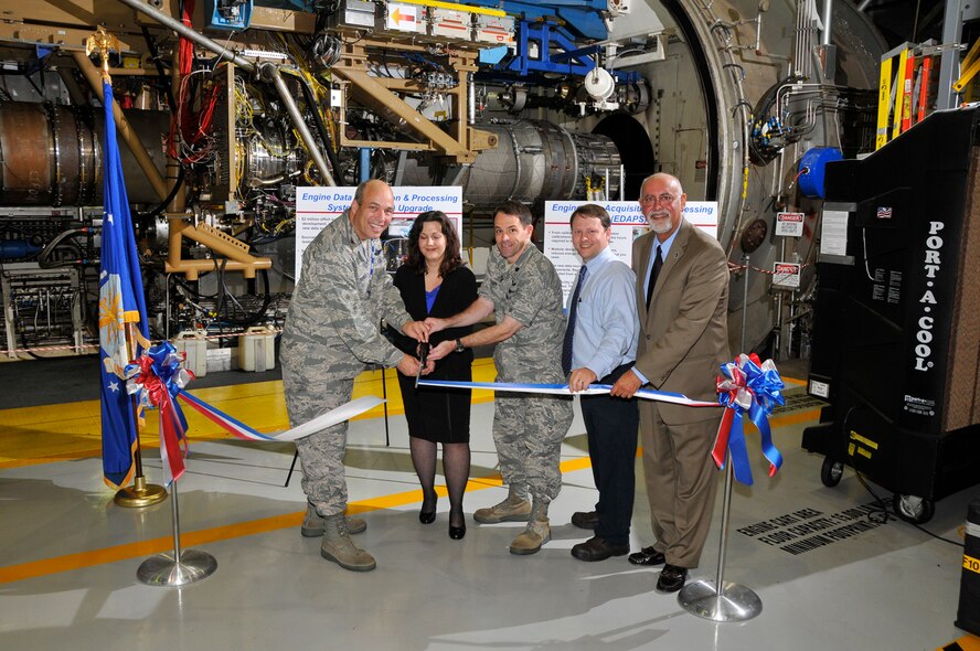 From left, On Sept. 22 2011, AEDC Commander Col. Michael Brewer; Melissa Tate, TTSIB Air Force project manager; Lt. Col. Brent Peavy, AEDC’s Turbine Engine Ground Test Complex director; Cameron Liner, TSDIB Air Force data acquisition and network engineer; and Dr. Saeed Zadeh, Test Systems Division’s Investments Branch (TTSI) director, took part in the EDAPS upgrade ribbon-cutting ceremony in the J-1 test cell. (Photo by Rick Goodfriend)