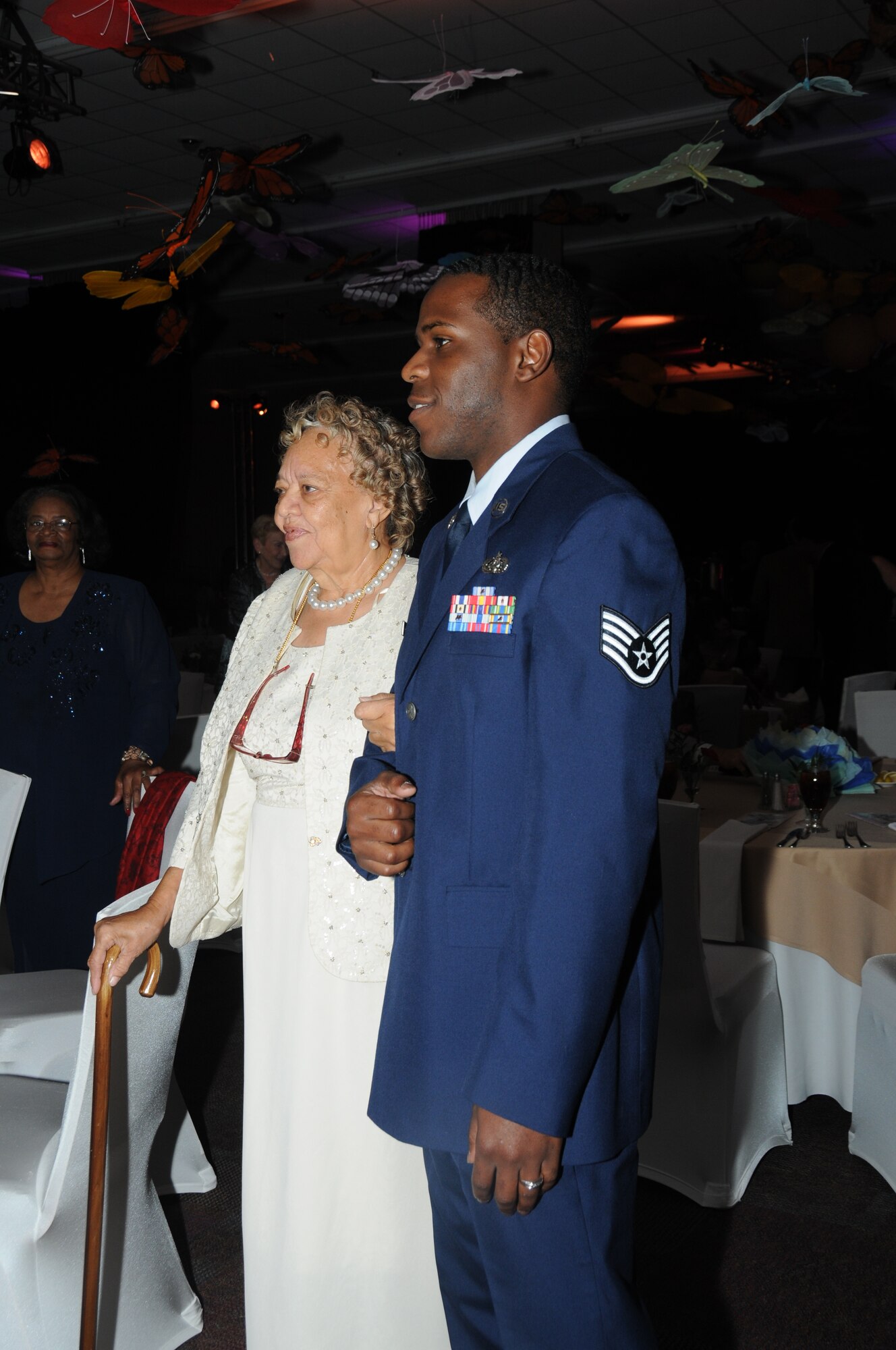 Joann Williams of Gulfport and Staff Sgt. Lakendrick Fisher, 85th Engineering Installation Squadron, Keesler Air Force Base, Miss., pause for a photo as he escorts her to her seat during the fifth annual Mississippi Gulf Coast Senior Prom at the IP Casino Nov. 17, 2011.  Other Keesler Airmen in attendance volunteered for the event sponsored by the Harrison County Development Commission and the Gulf Coast Retiree Partnership with more than 800 people in attendance.  (U.S. Air Force photo by Kemberly Groue)