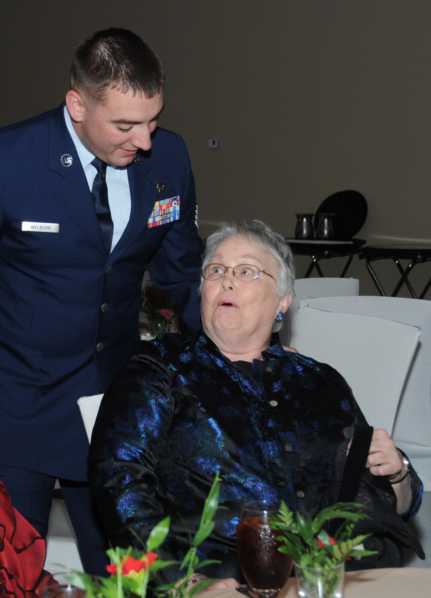 Staff Sgt. Jeremi Welborn, 85th Engineering Installation Squadron, Keesler Air Force Base, Miss., assists Evelyn Ring of Moss Point with her seat during the fifth annual Mississippi Gulf Coast Senior Prom at the IP Casino Nov. 17, 2011.  Other Keesler Airmen also volunteered for the event sponsored by the Harrison County Development Commission and the Gulf Coast Retiree Partnership with more than 800 people in attendance.  (U.S. Air Force photo by Kemberly Groue)