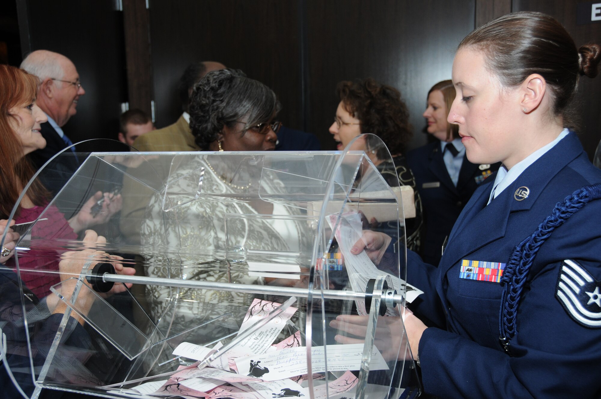 Tech. Sgt. Shannon Danko, 366th Training Squadron, Det. 6, Naval Mobile Construction Battalion, Miss., collects tickets from guests during the fifth annual Mississippi Gulf Coast Senior Prom at the IP Casino Nov. 17, 2011.  Danko was one of many Airmen in attendance volunteering for the event sponsored by the Harrison County Development Commission and the Gulf Coast Retiree Partnership with more than 800 people in attendance.  (U.S. Air Force photo by Kemberly Groue)
