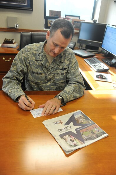 U.S. Air Force Col. Billy Thompson, 23rd Wing commander, fills out and signs a Combined Federal Campaign pledge sheet at Moody Air Force Base Ga., Nov. 17, 2011. The CFC supports eligible nonprofit organizations that provide health and human service benefits throughout the world. Last year, Moody raised more than $123,000 for communities throughout Georgia. The campaign is scheduled to run until Dec. 23. (U.S. Air Force photo by Airman 1st Class Paul Francis/Released)
